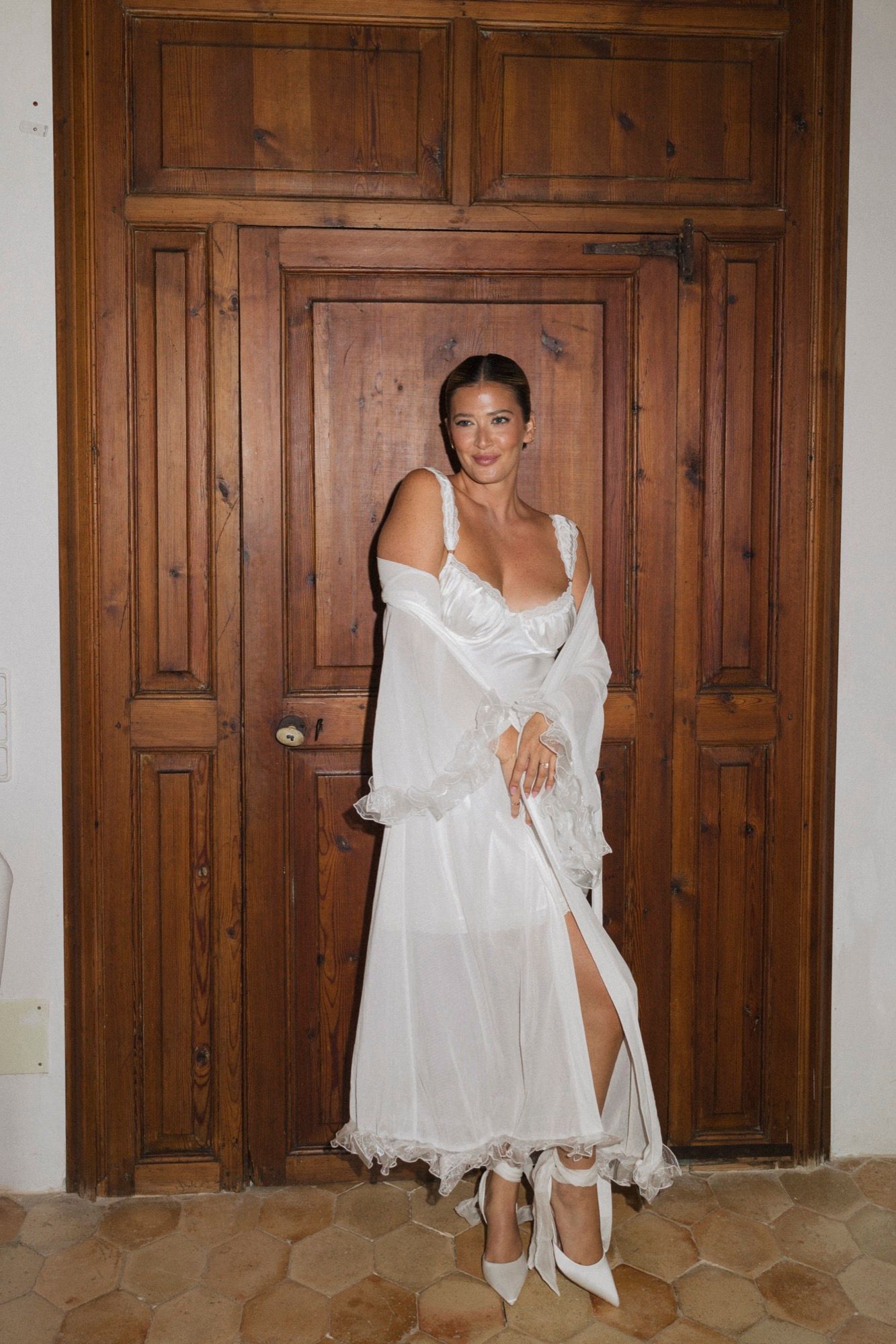 Series of shots showing white dress movement against wooden paneled walls.