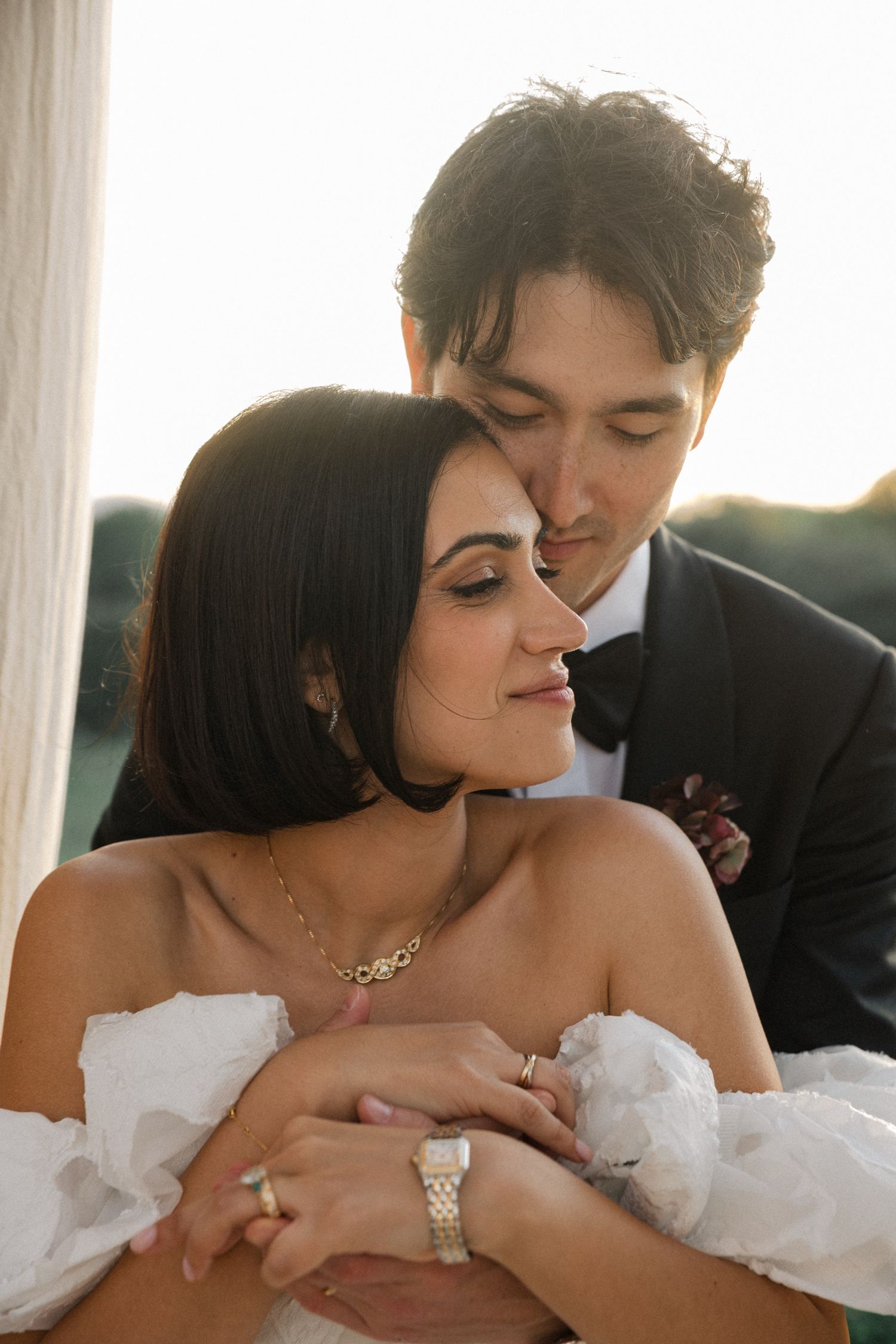 A romantic wedding sequence showing a tender moment between newlyweds in a soft, natural light setting. Es Racó d'Artà