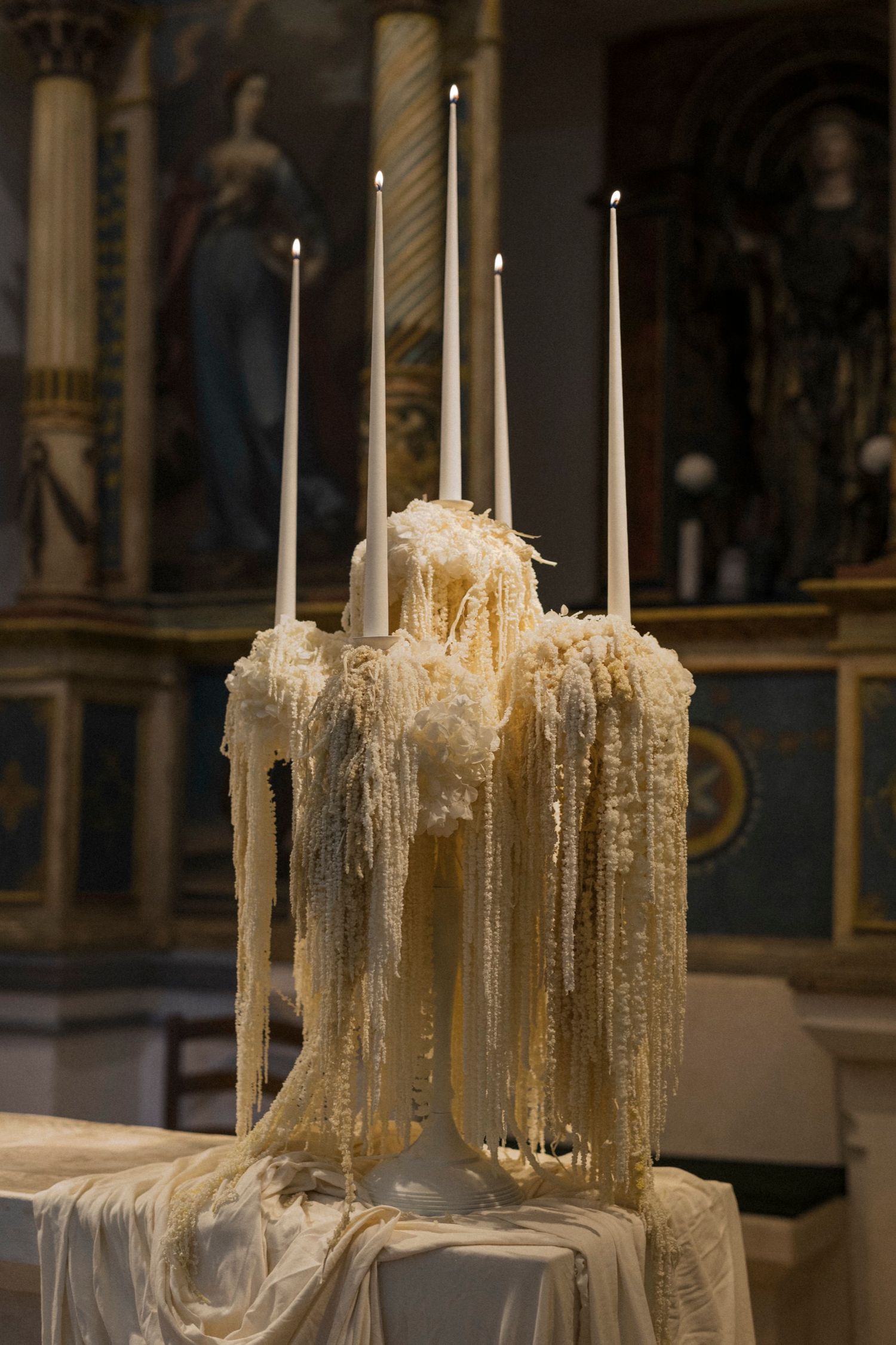 Melted candle wax creating dramatic drips and formations on candlesticks.