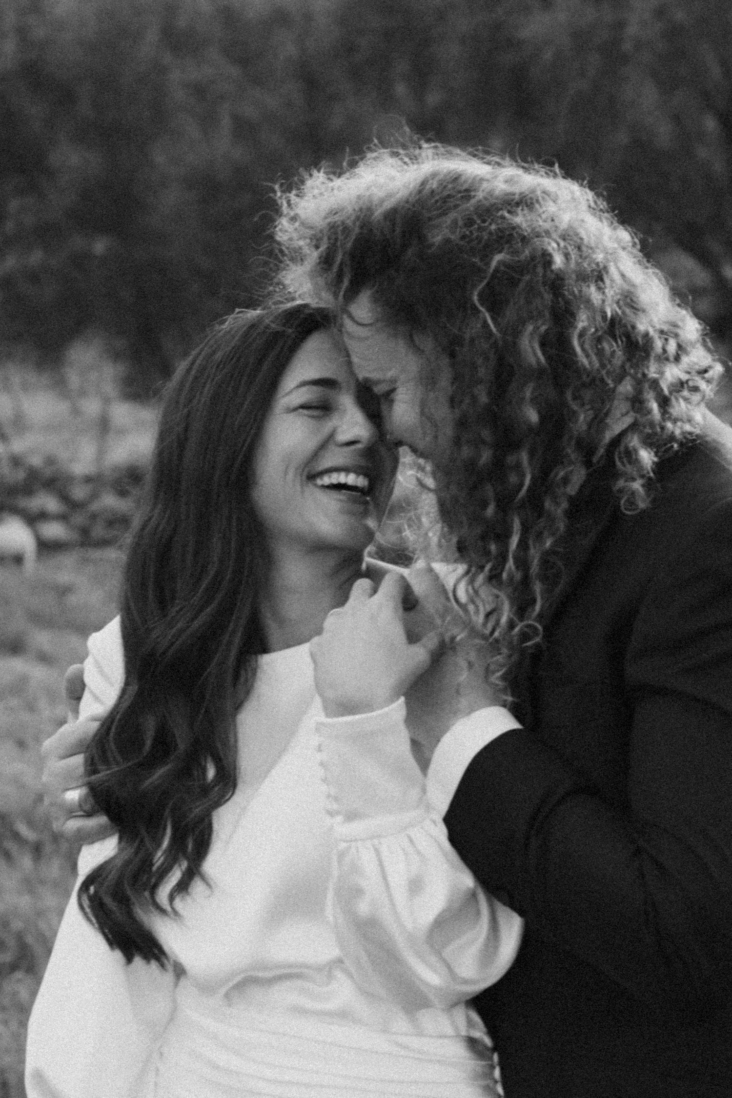 A romantic black and white photo sequence showing a couple in white shirts sharing intimate moments together.