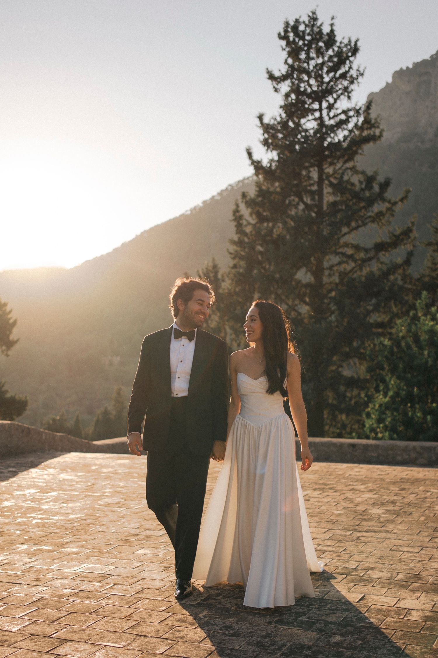 A bride and groom share romantic moments at sunset against a mountain backdrop in a series of wedding photos.
