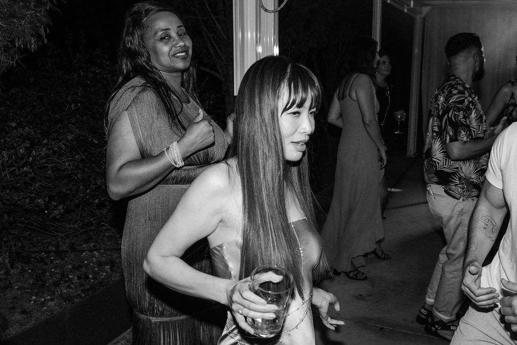 Candid black and white photos show wedding guests dancing and celebrating.