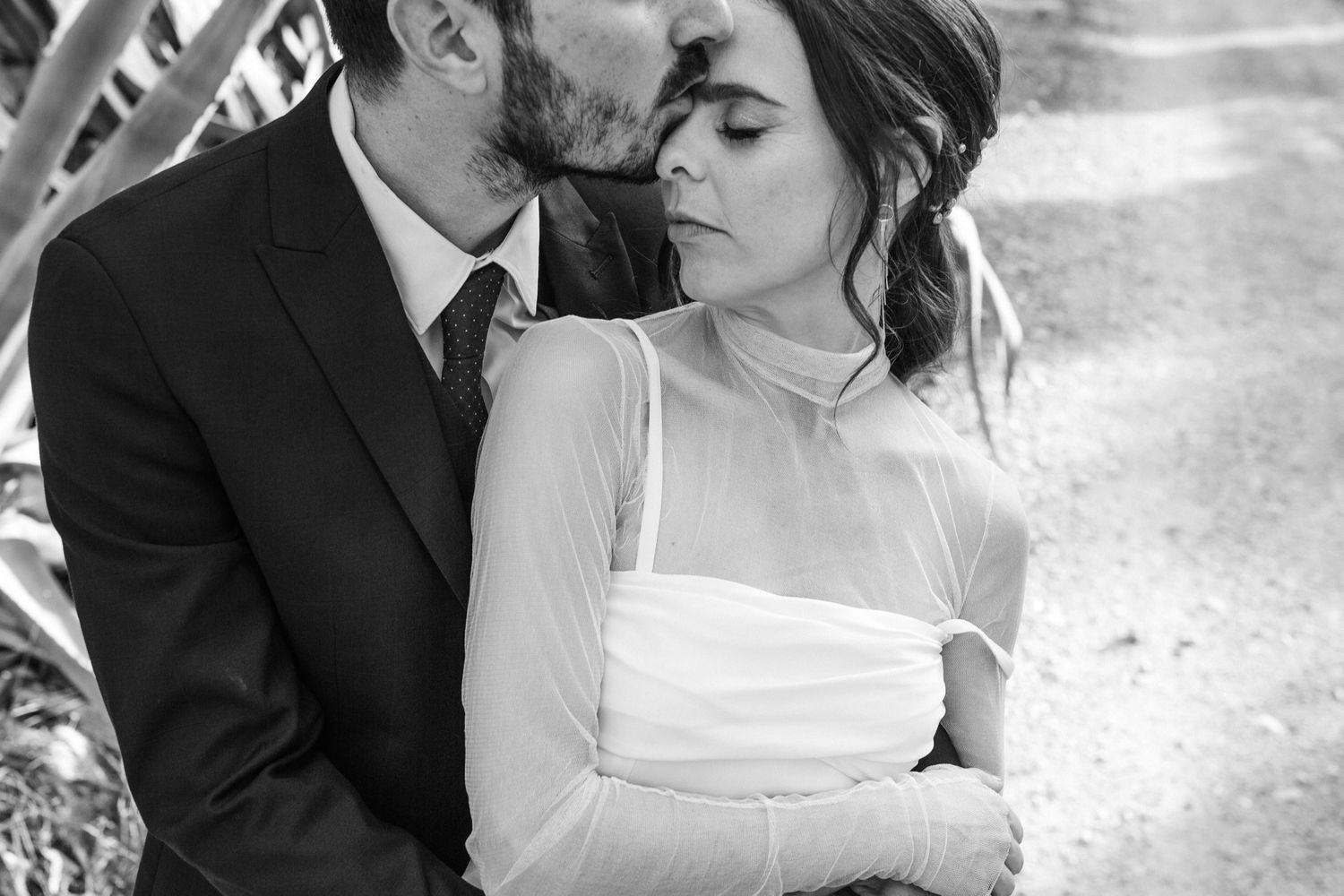 A romantic black and white wedding photo collage showing intimate moments between newlyweds.