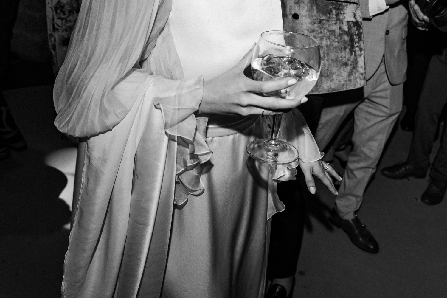 A series of black and white wedding photos showing dancing and celebration at a reception.