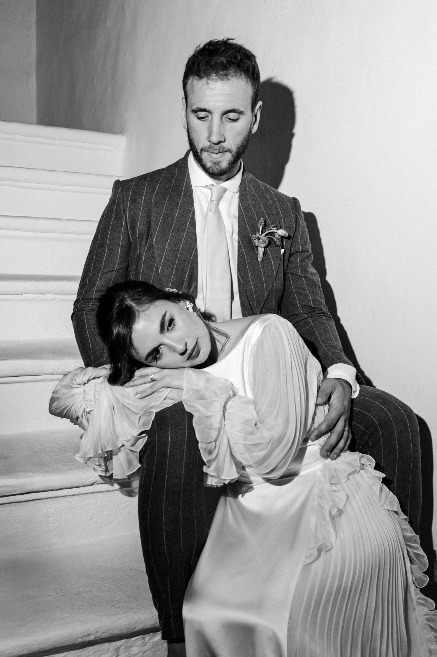Black and white photo series showing intimate dance-like poses between two people in formal attire.