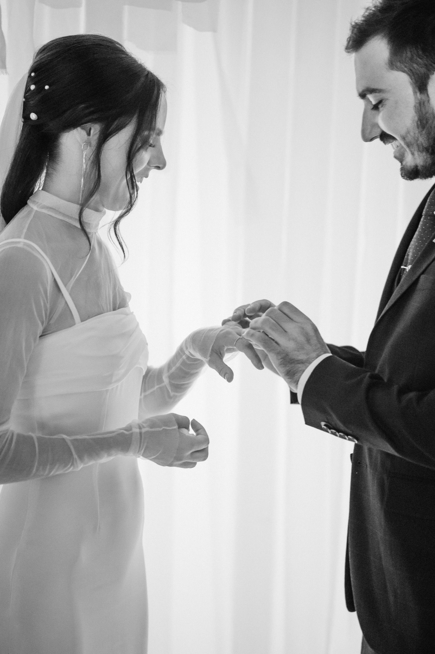 Black and white sequence of a couple sharing an intimate moment with curtains in the background.