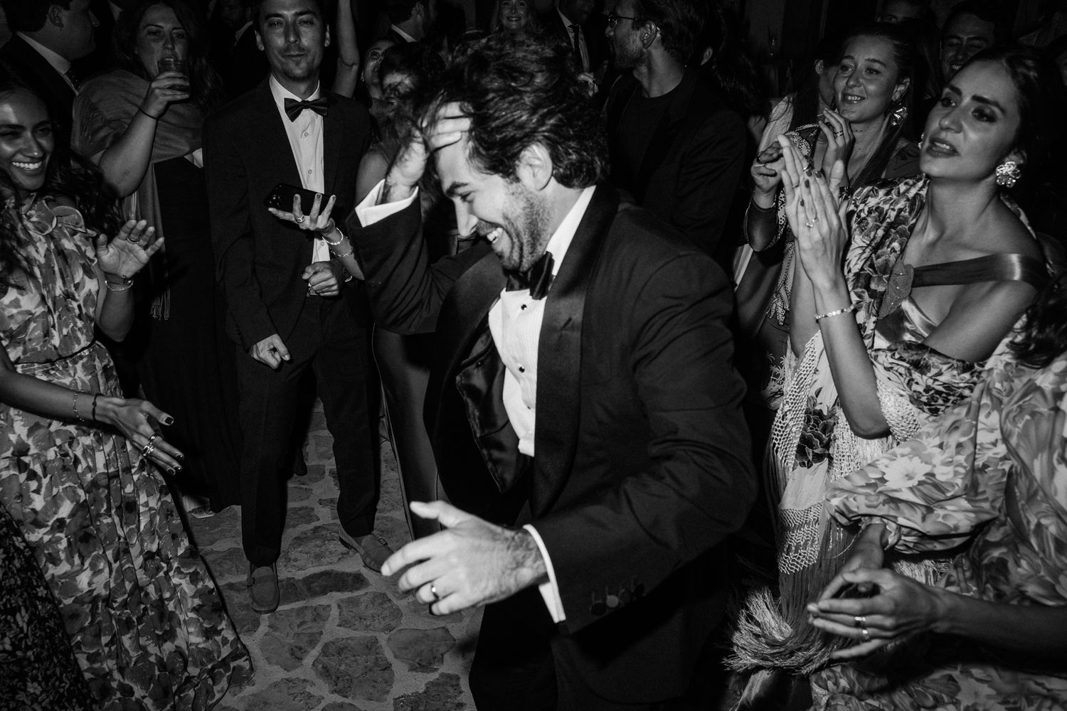 Guests enjoying themselves on a dance floor at an elegant formal event with people dancing and celebrating.