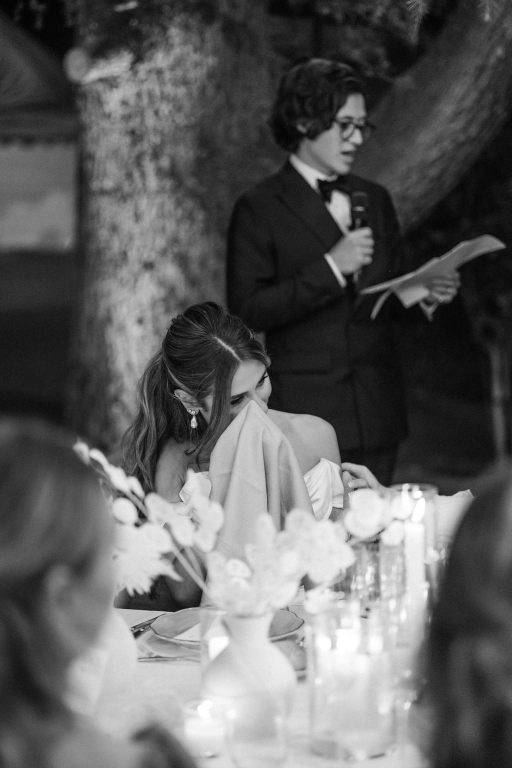 Candlelit wedding reception table with glowing centerpieces creating romantic ambiance.