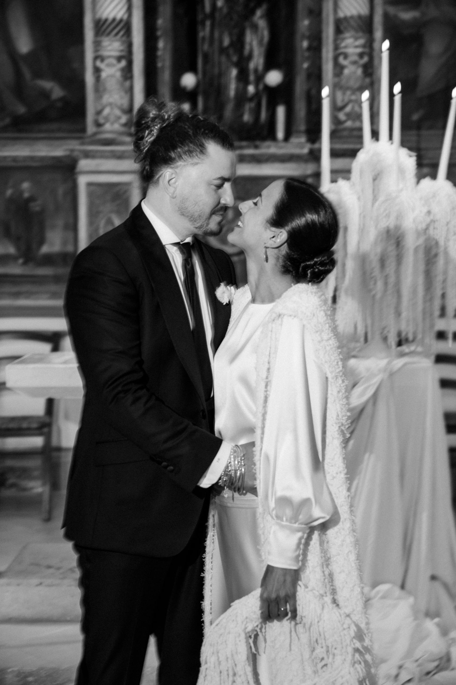 Romantic moment captured between newlyweds in a beautifully decorated church setting.