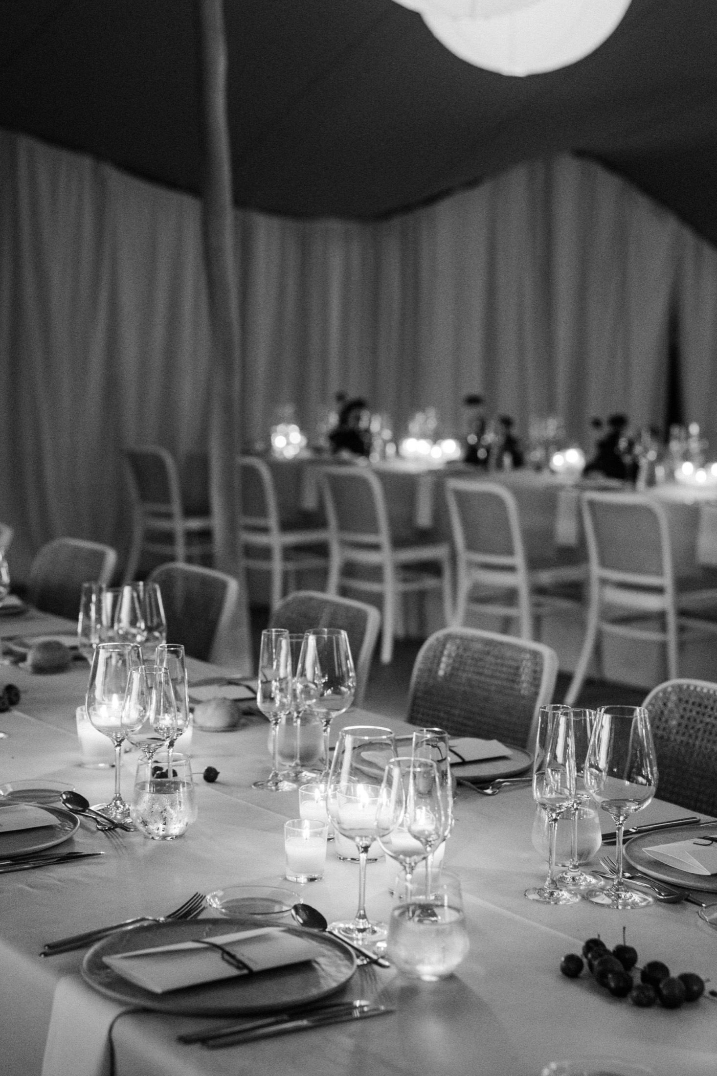 Elegant table settings with wine glasses and place settings arranged in a monochromatic black and white style.