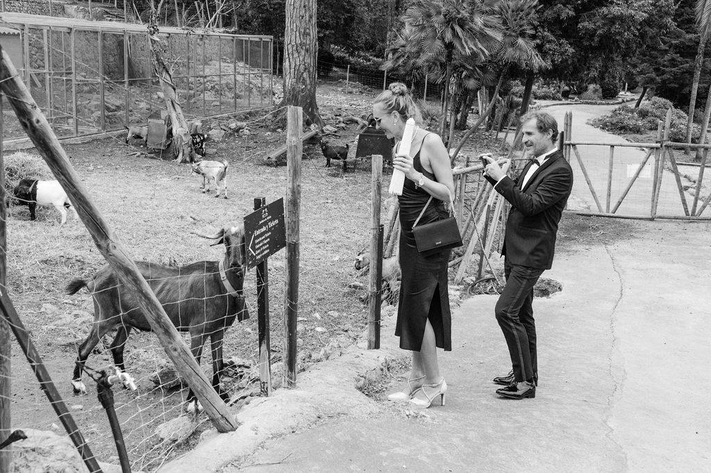 Black and white photograph of people gathered at an outdoor social event.