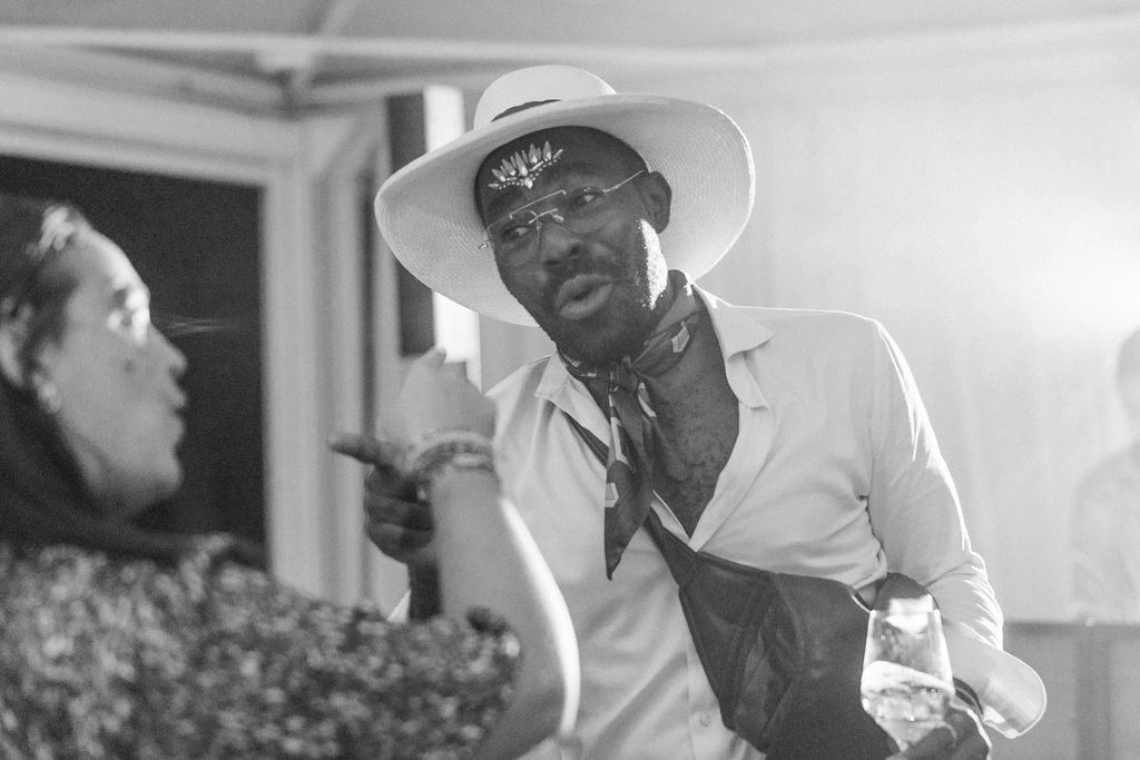 Black and white candid shots capture guests enjoying themselves at a wedding reception.