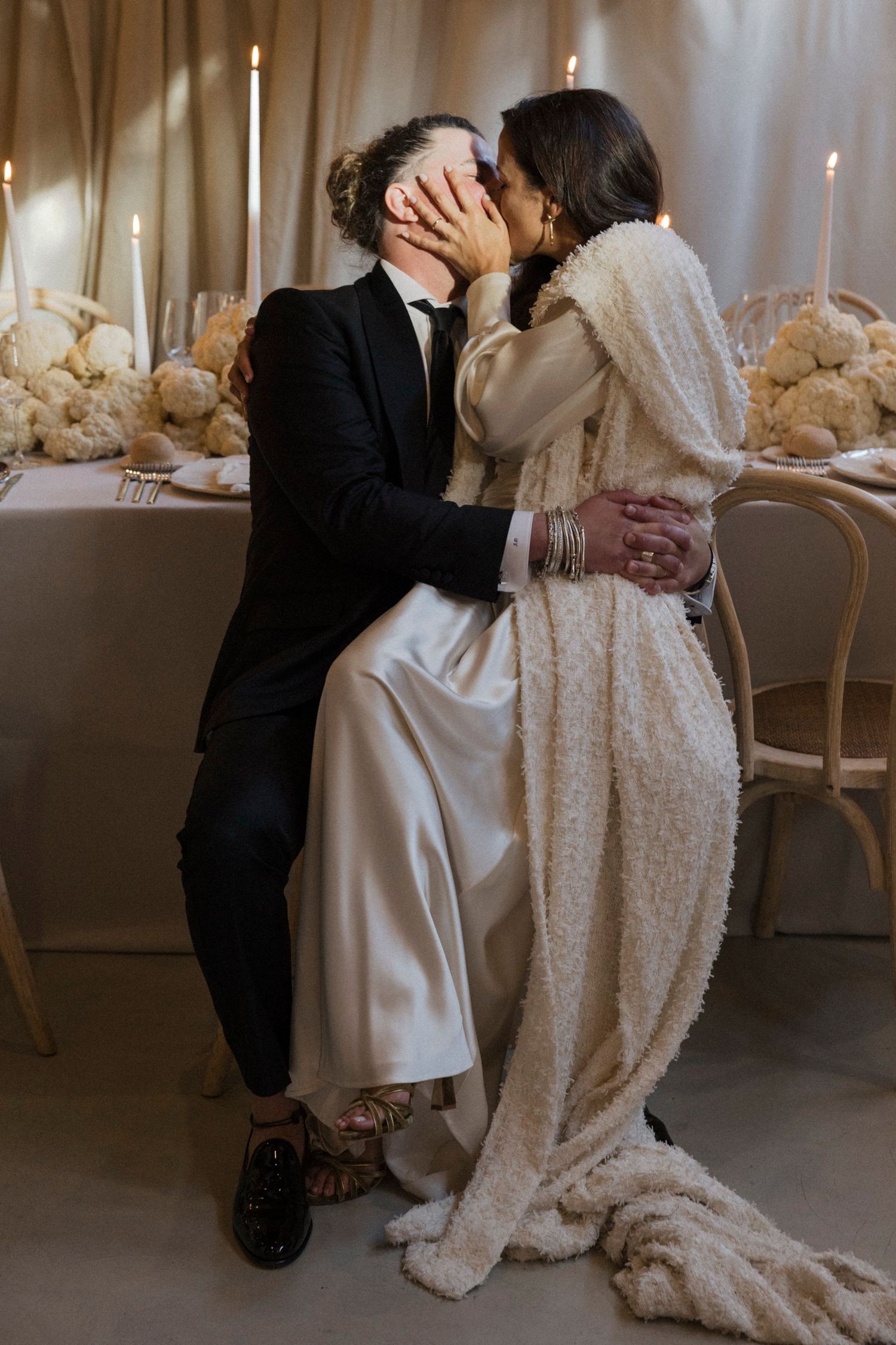 Romantic wedding couple sharing intimate moments at an elegantly decorated reception.