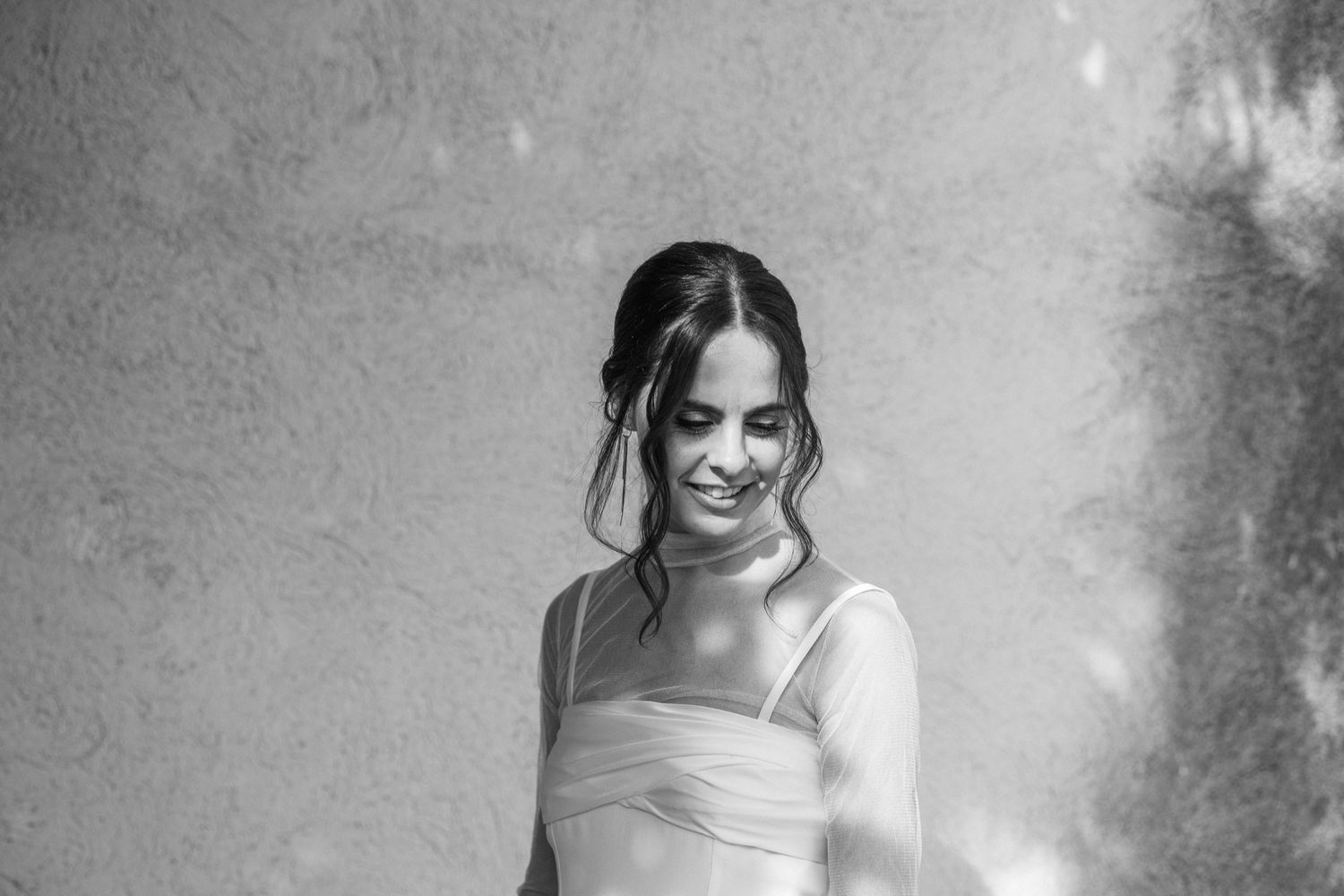 A series of black and white photos showing a person in a white dress posing in different romantic outdoor settings.