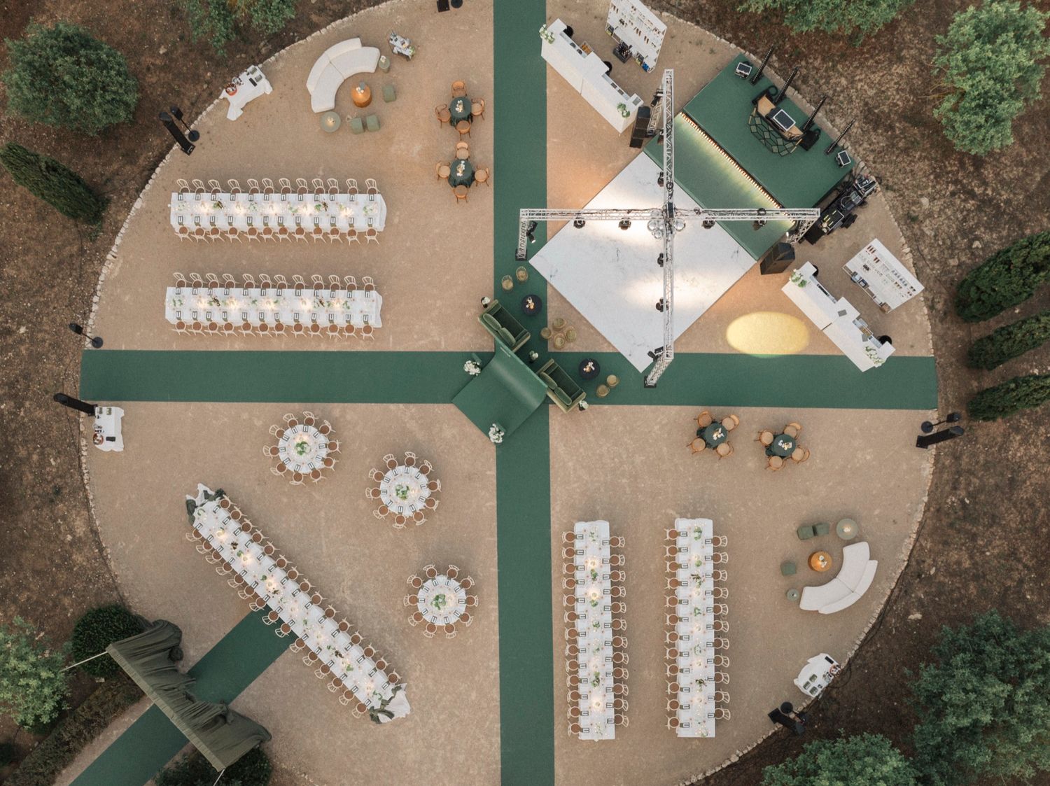 Bird's eye view of a wedding reception layout with white tables and chairs on a terrace.
