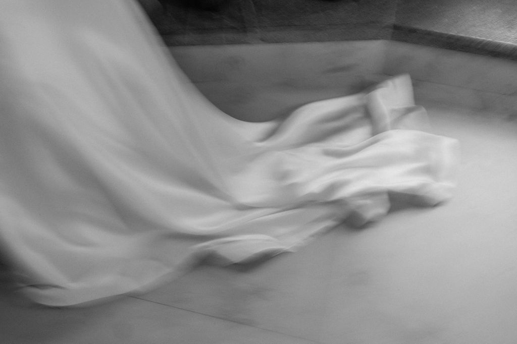 Artistic black and white motion blur effect creates an ethereal wedding photography sequence.