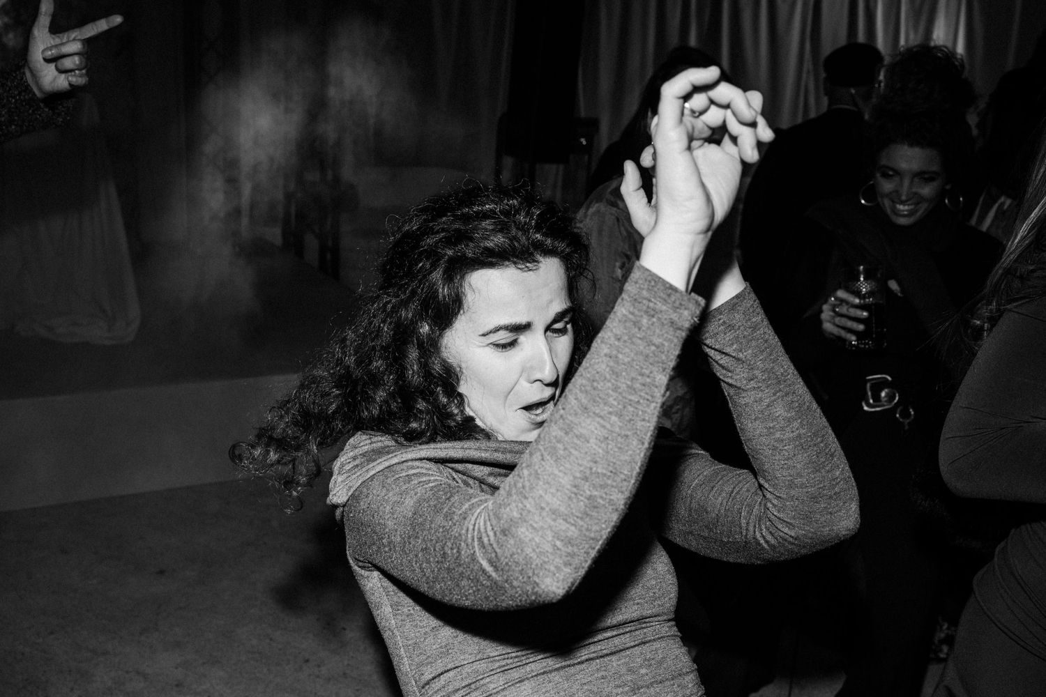 Black and white photo of people dancing at a celebration.