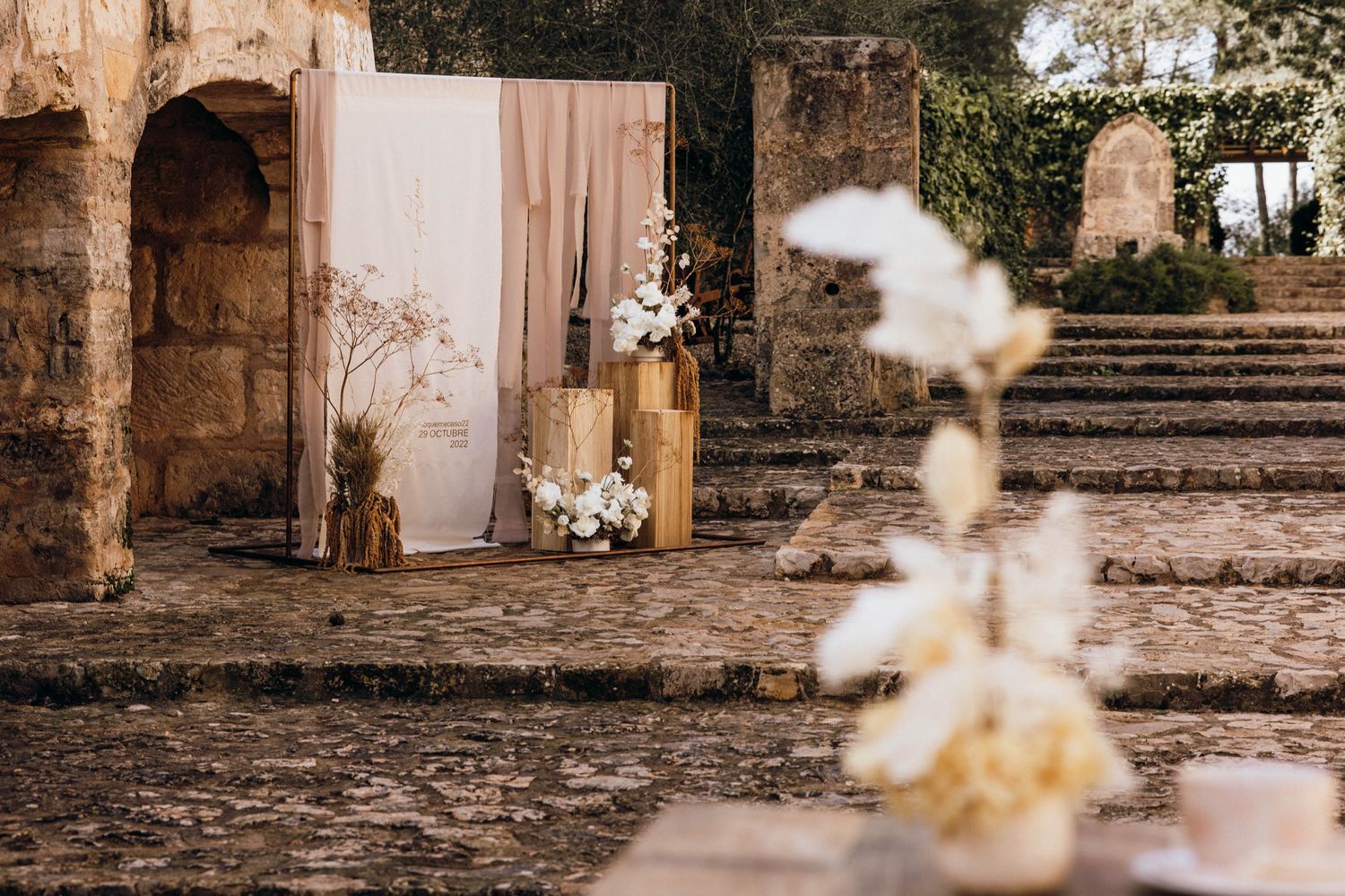 A romantic wedding photo collage showing stone architecture, blossoming flowers, and rustic outdoor settings.