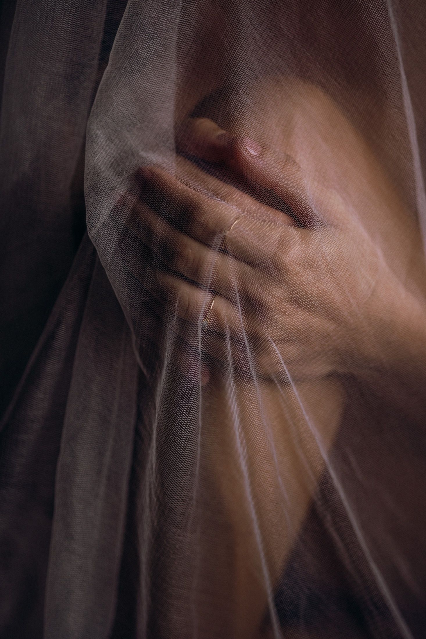 Blurred motion sequence showing hands in motion against a dark background creating an abstract artistic effect.
