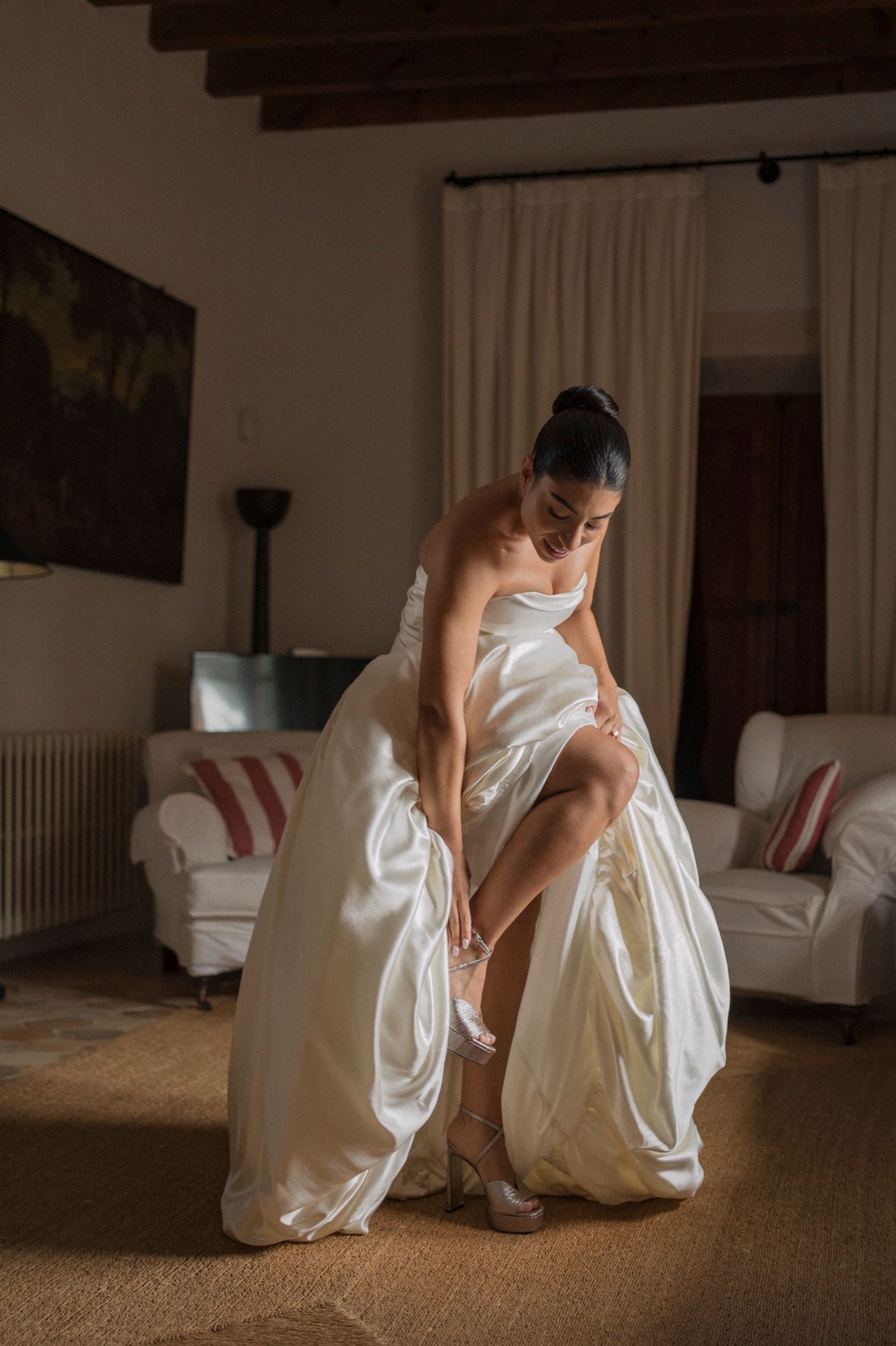 Sequence of photos showing someone in a white dress crouching down on a carpeted floor in a living room setting.
