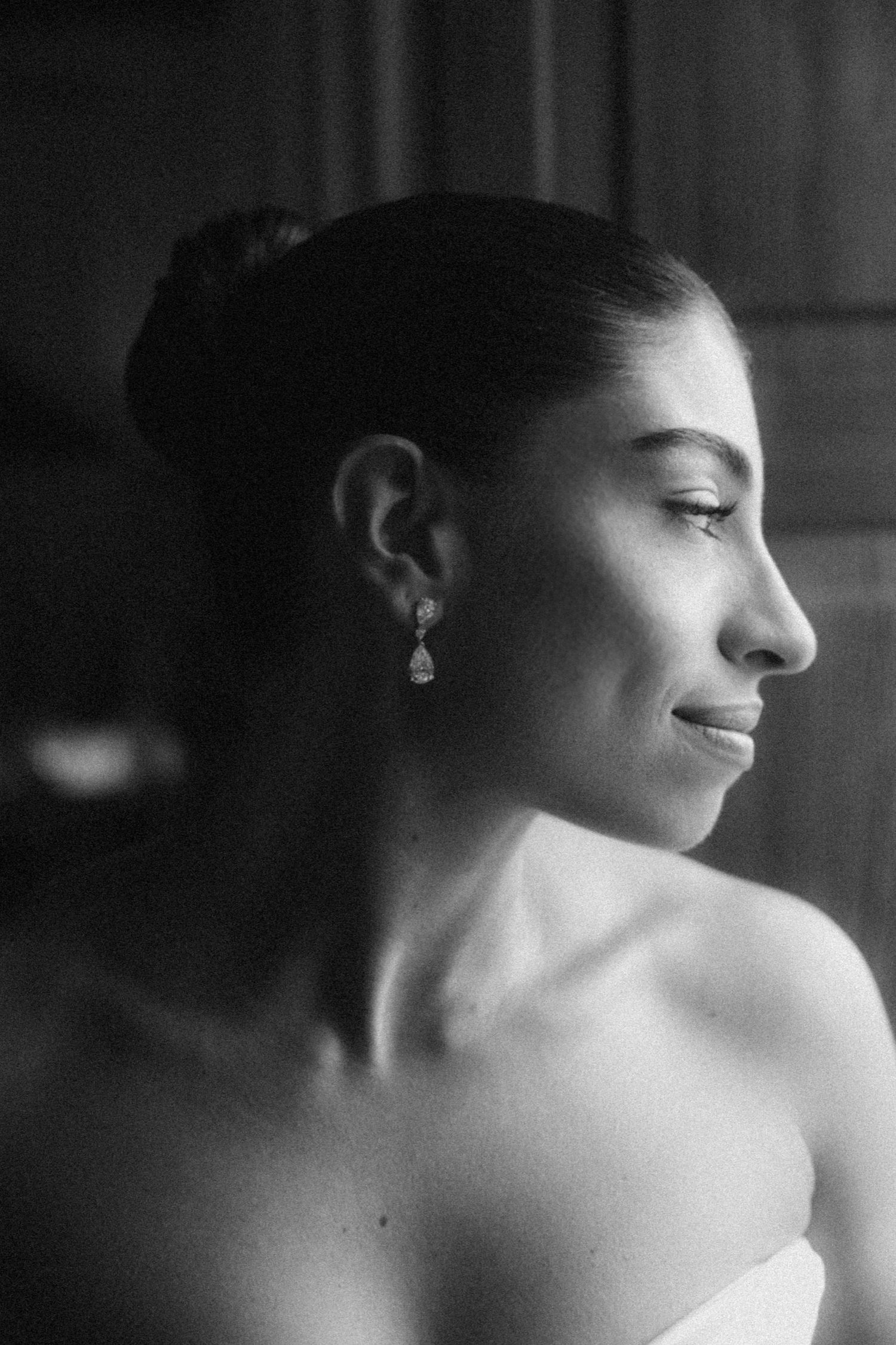 A black and white artistic portrait series showing the bare shoulders and profile of a woman in soft lighting.