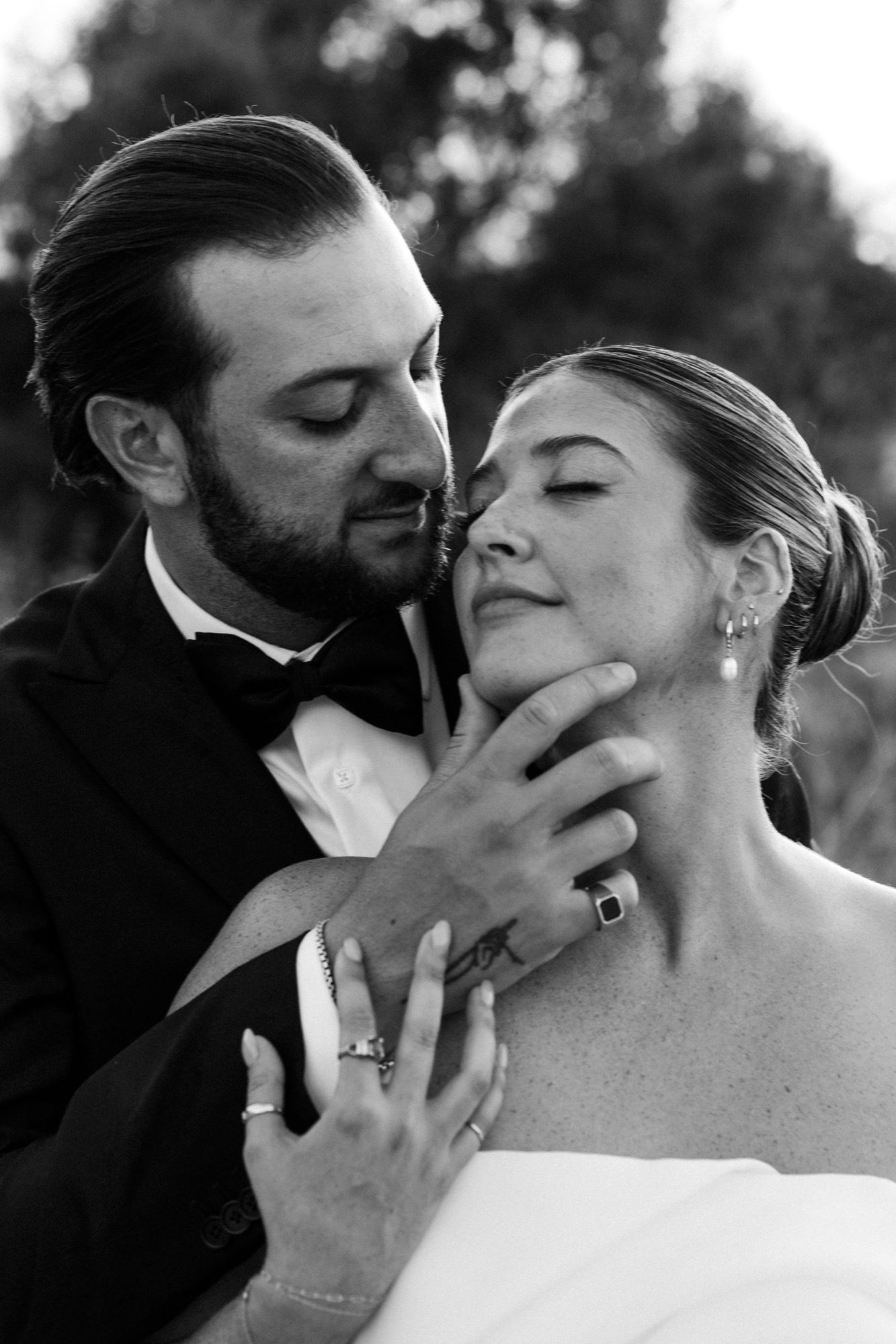 Black and white intimate wedding portraits capture tender moments between newlyweds.