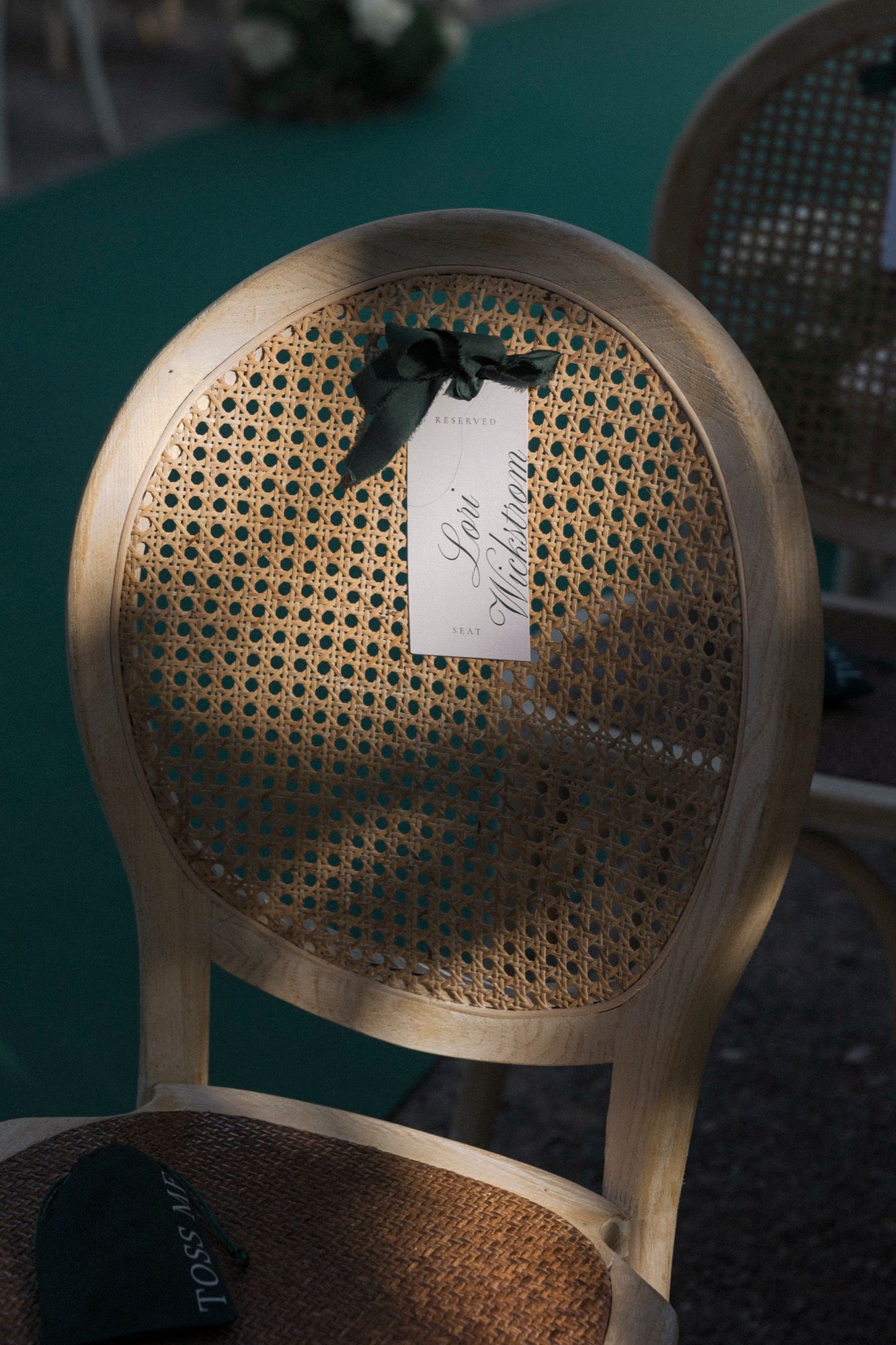 Detailed shot of a woven mesh wedding chair back with decorative elements.