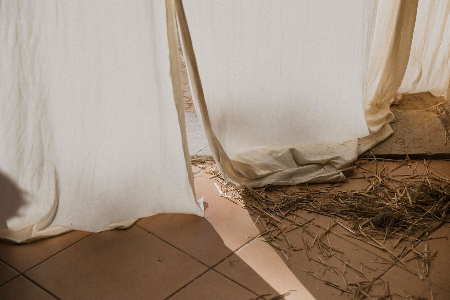 Artistic detail shots of flowing white wedding dress fabric.