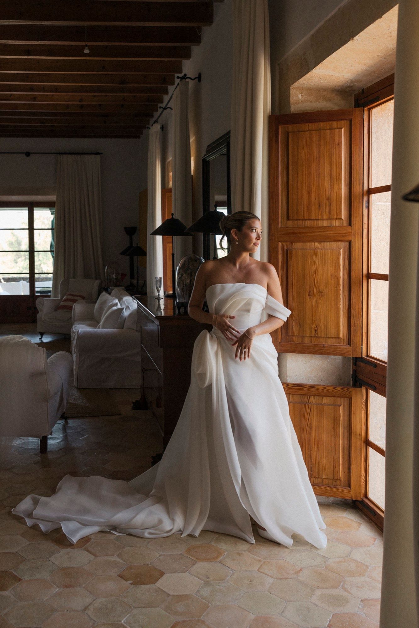Series showing flowing white dress movement in sunlit room with wooden doors.