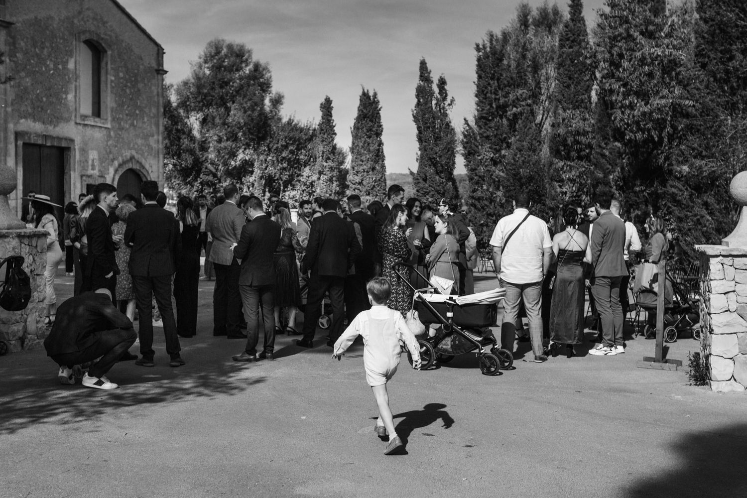 A sequence of black and white wedding photos showing guests gathering outside a church after a ceremony.