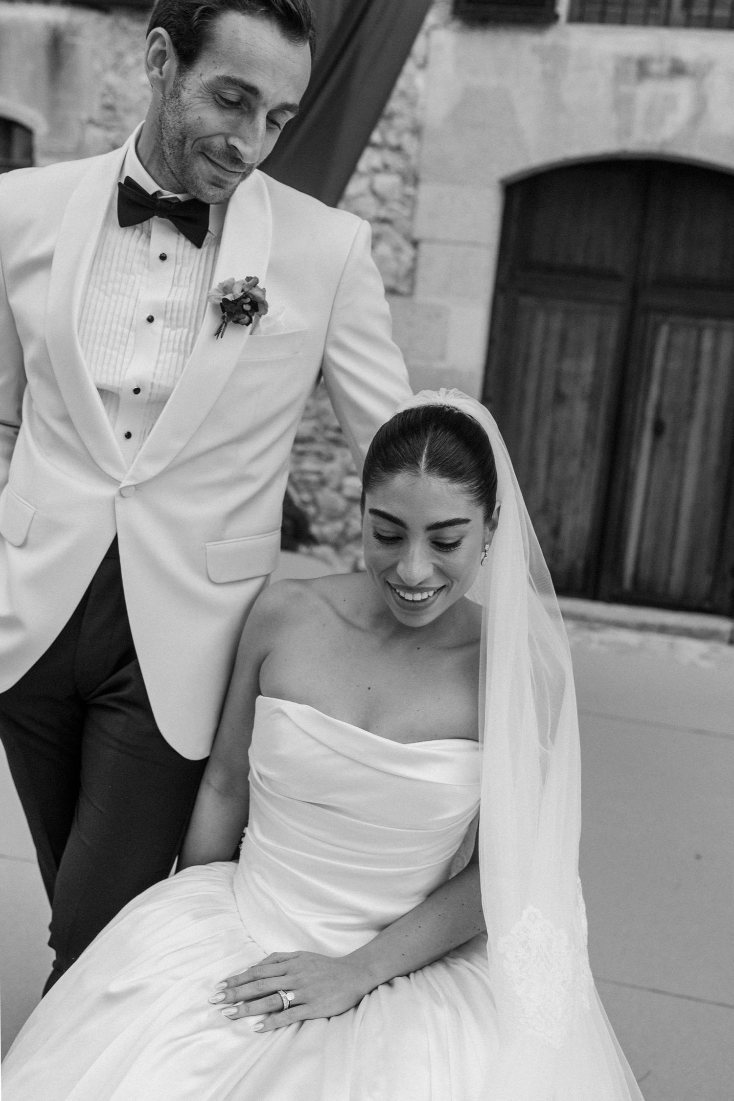 A black and white wedding photo collage showing tender moments between a couple in formal attire.