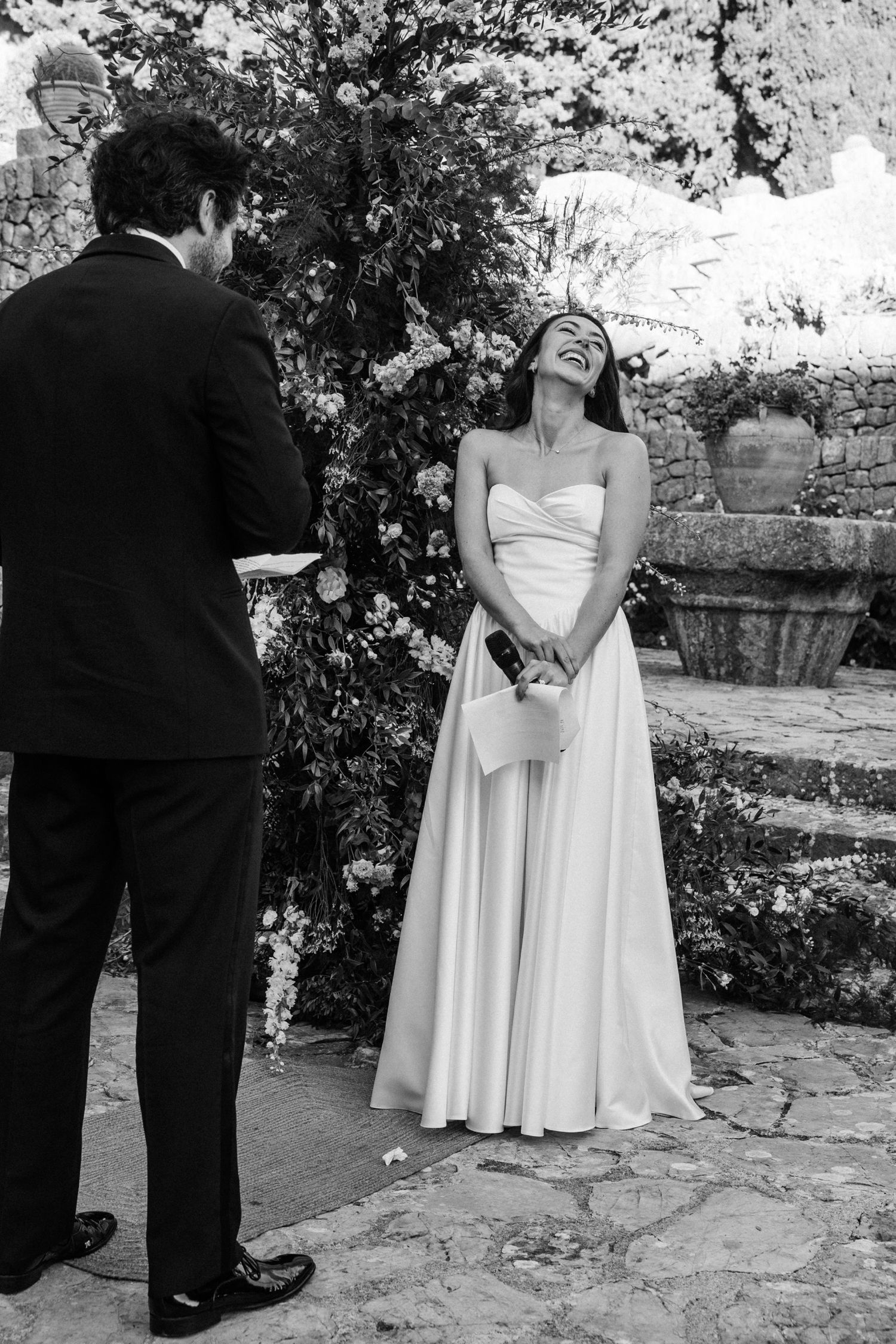 A sequence of black and white wedding photos showing a couple in formal attire on stone steps in a garden setting.