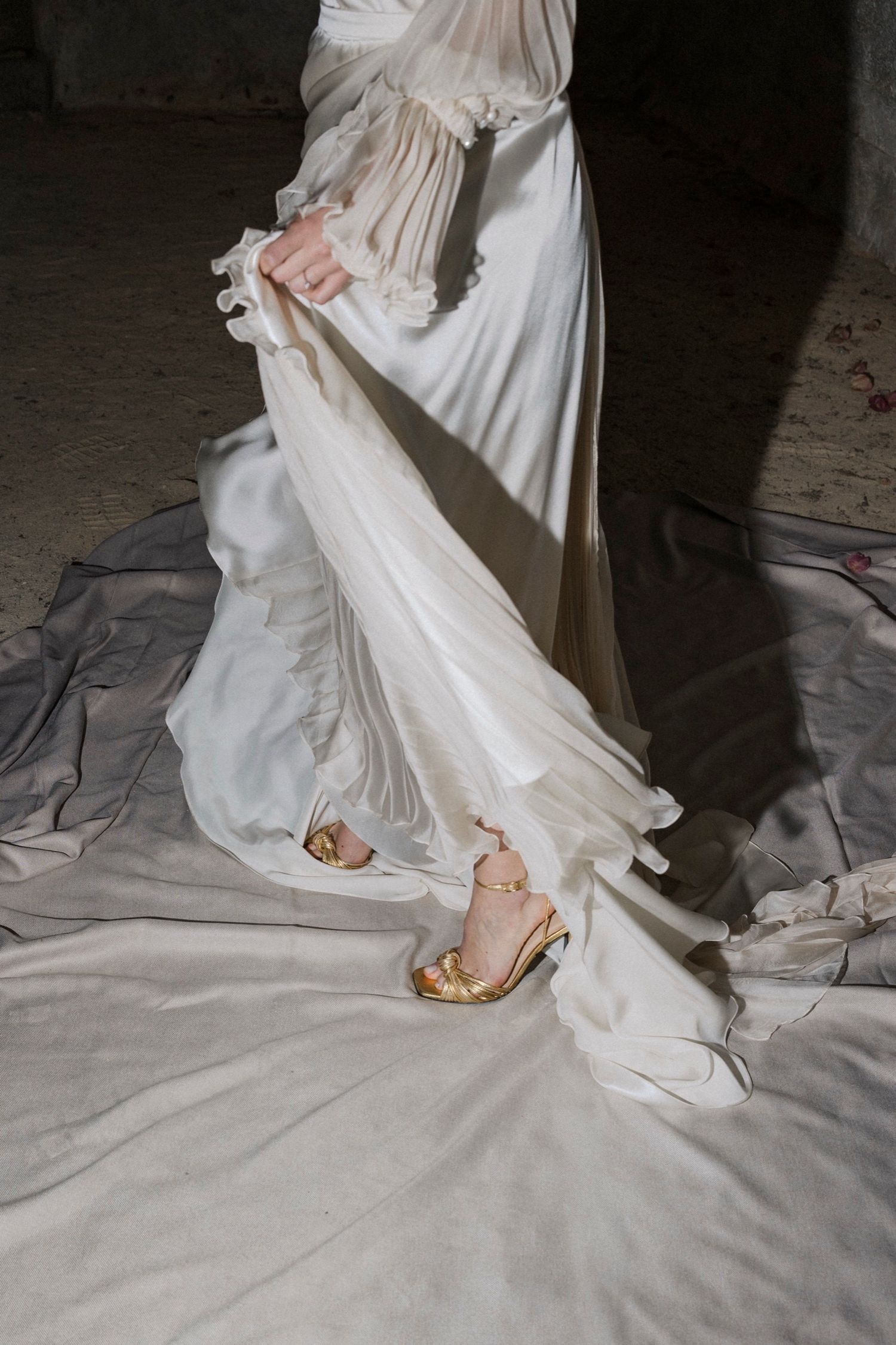 A series of close-up shots showing the hem and shoes of a flowing white wedding dress against a light colored floor.