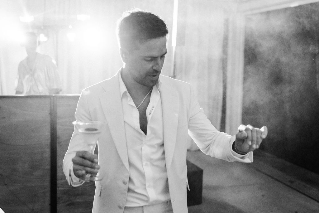 Black and white photos capture the energy of guests dancing at a wedding reception.