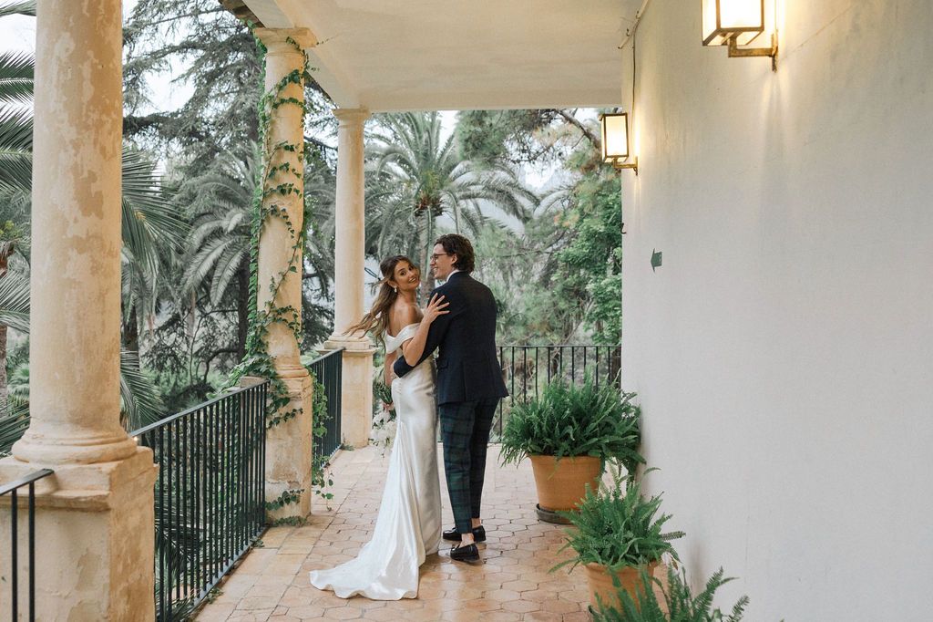 Wedding photography session on Mediterranean style porch with hanging lanterns.