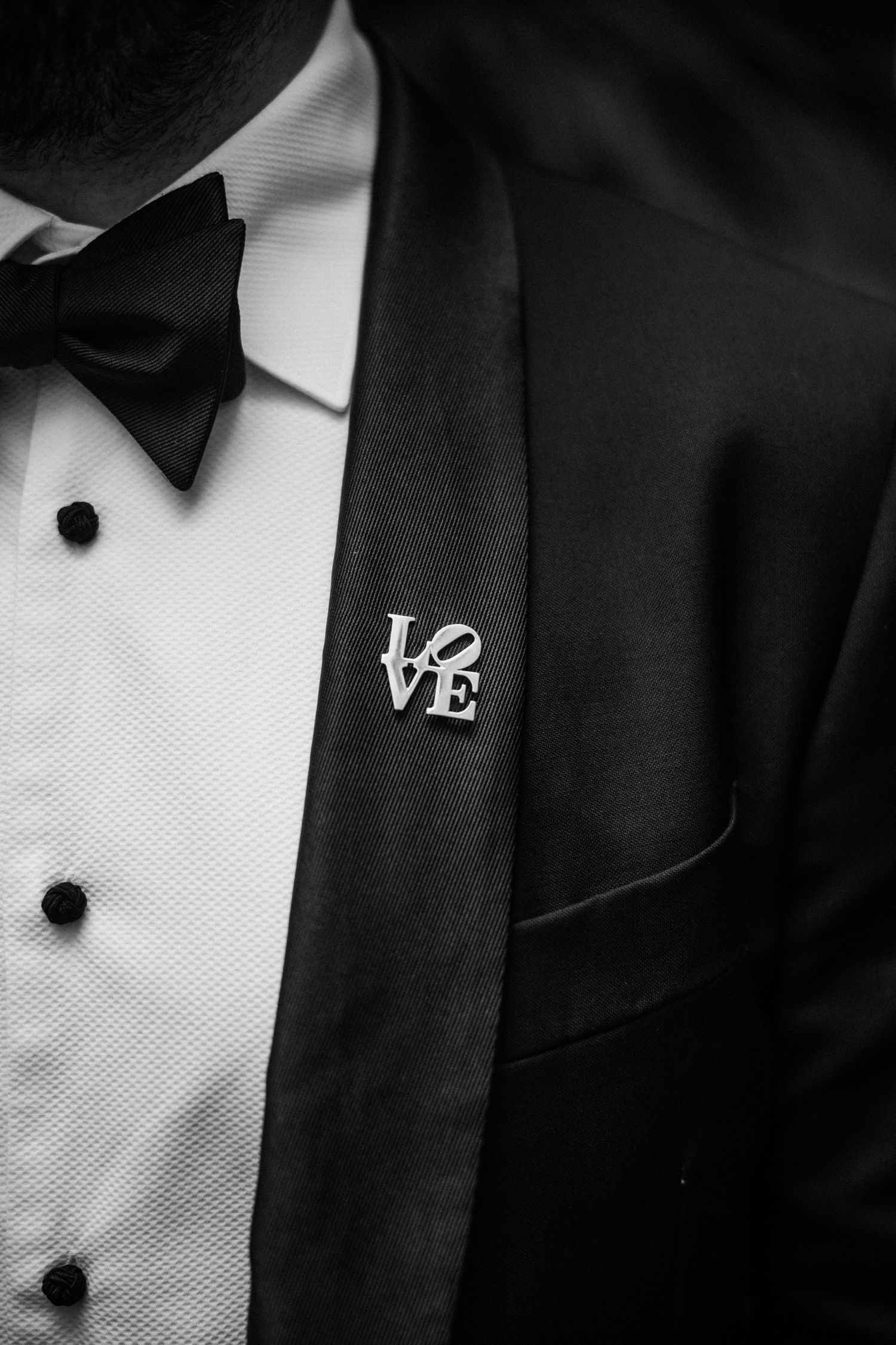 Black and white close-up detail shots of formal tuxedo jackets with bow ties and white dress shirts.