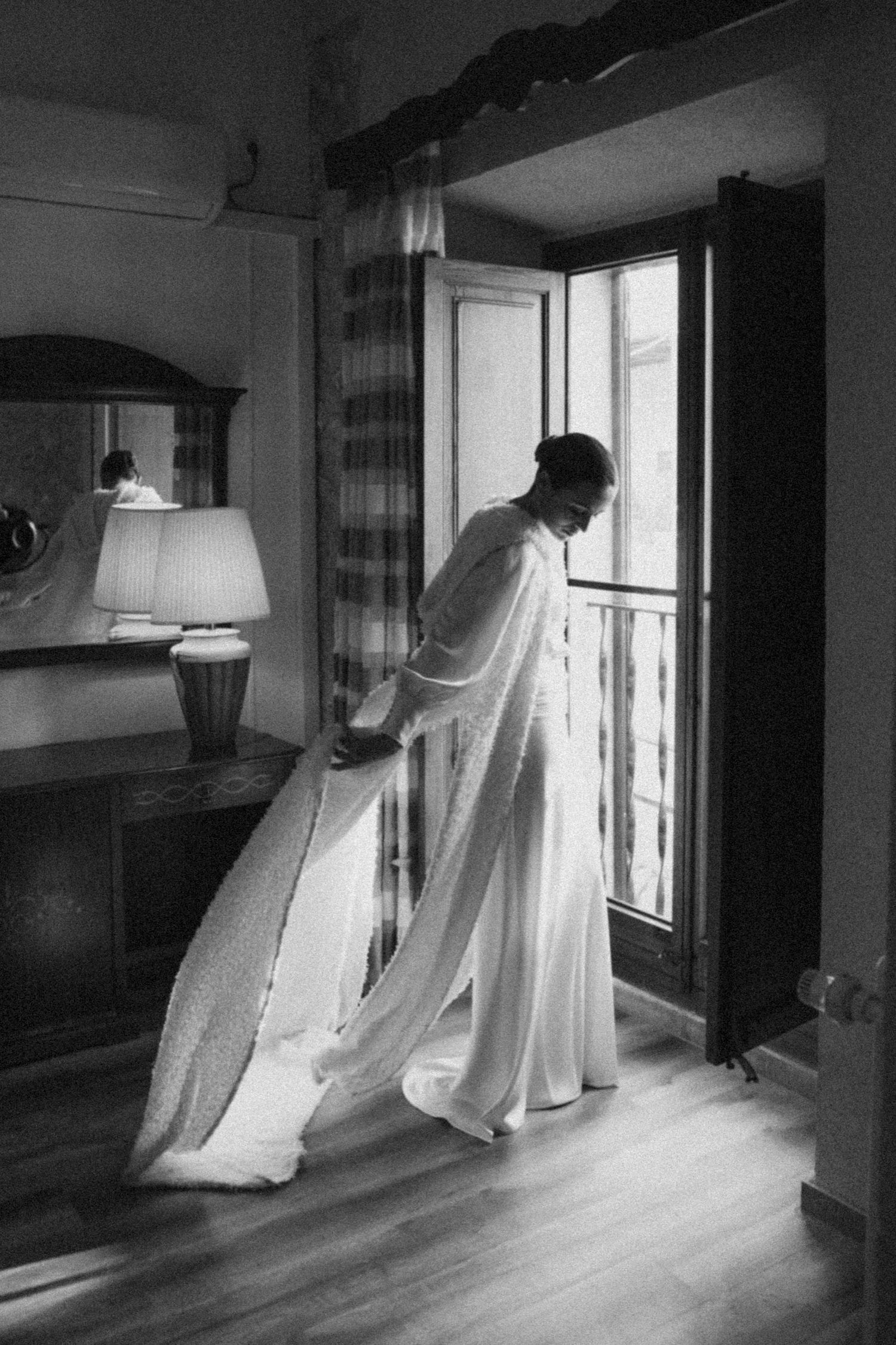 Ethereal white fabric installations floating in front of sunlit windows.