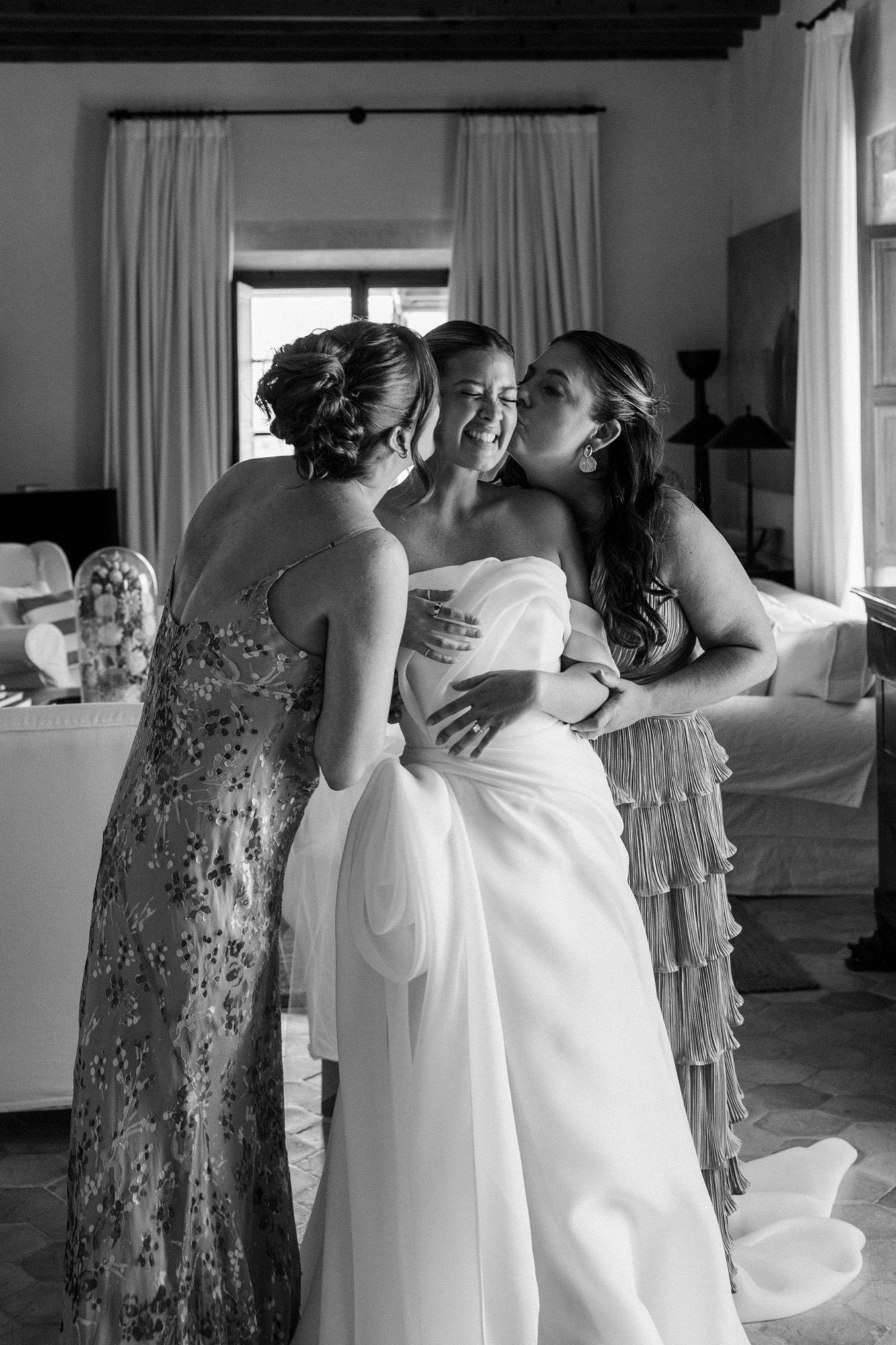 Wedding preparation scene showing a sparkly dress and white gown in an elegant room with curtains.