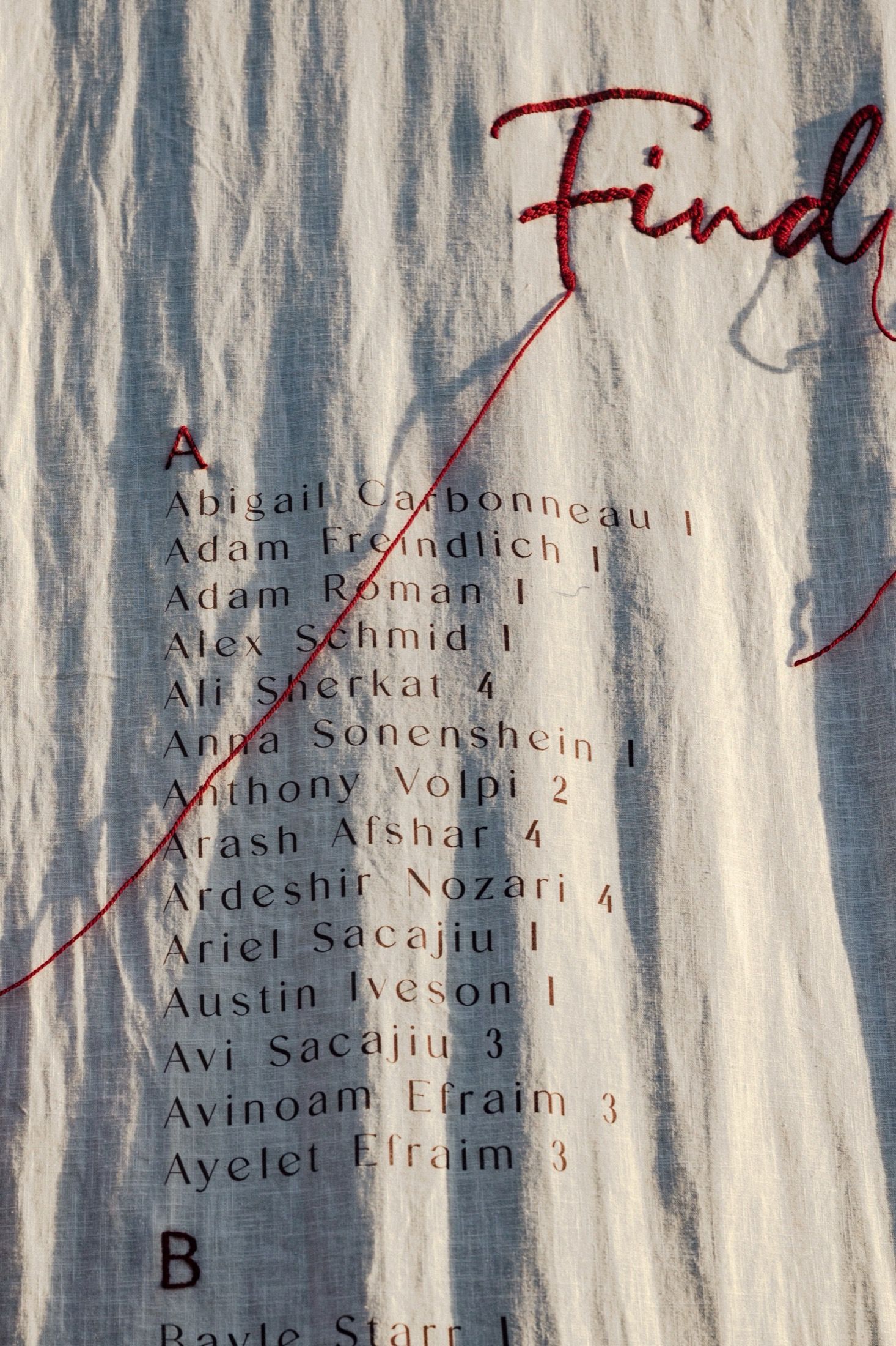 A blurred list of names appears against a textured blue and white striped background.