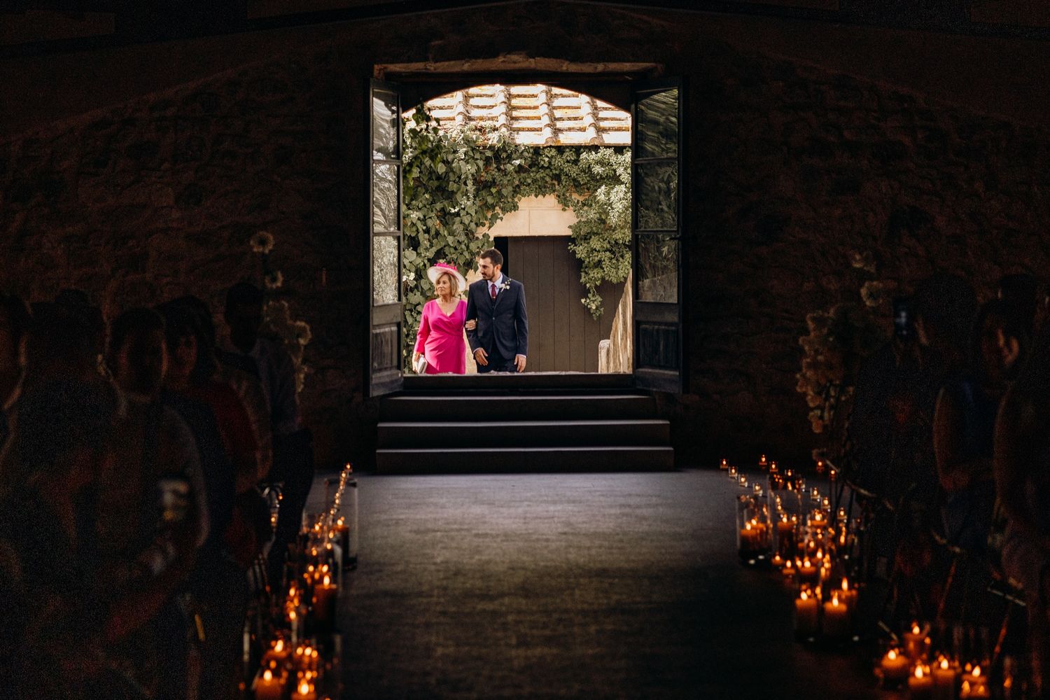 Dark stone staircase illuminated by glowing orange lights along the walls leads upward into darkness.