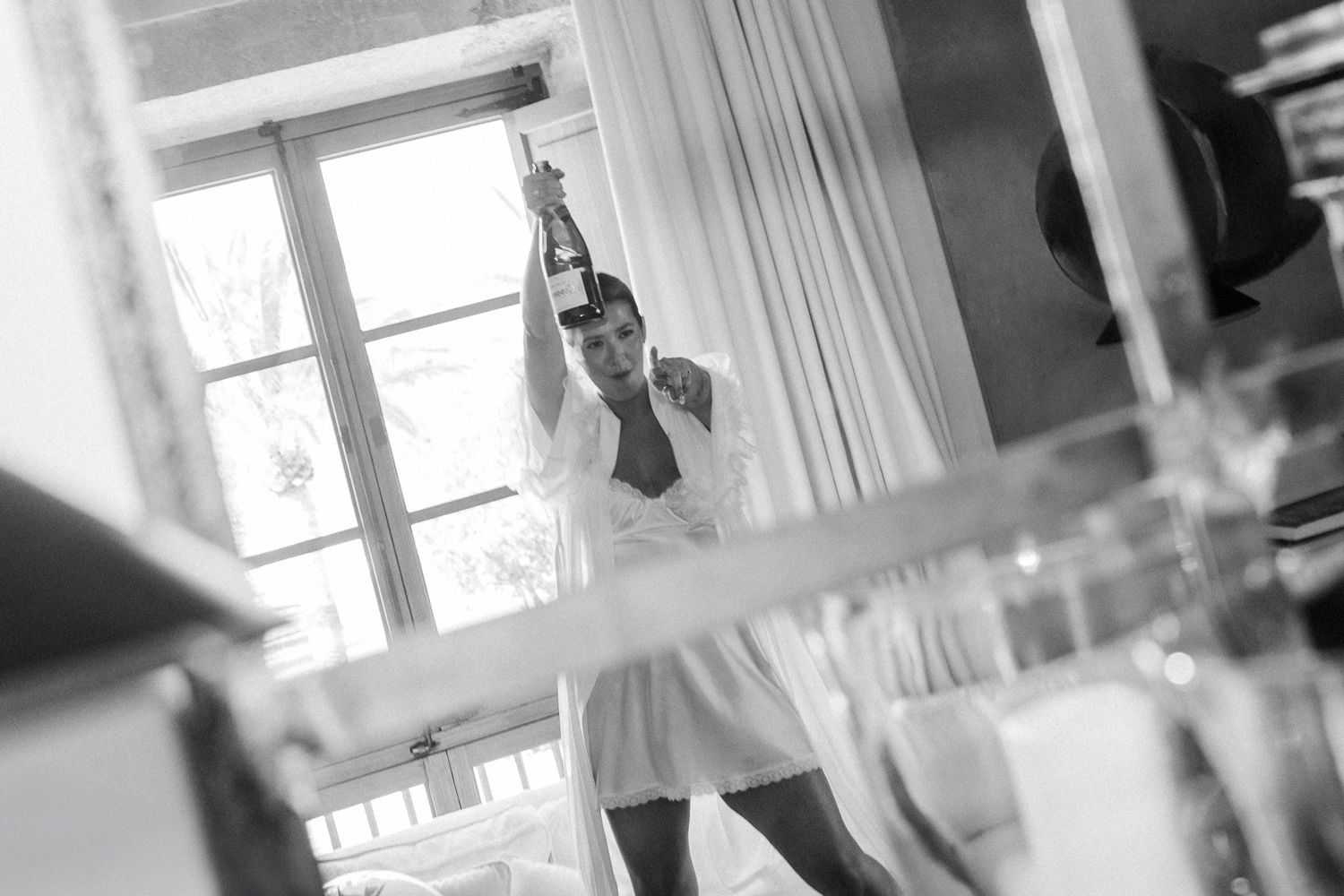 Soft focus black and white images showing movement and light through curtained windows.