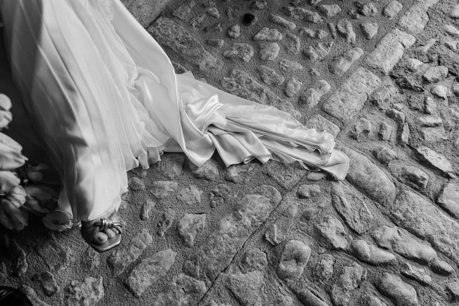 A series of black and white photographs showing close-up details of cobblestone streets and stone surfaces.