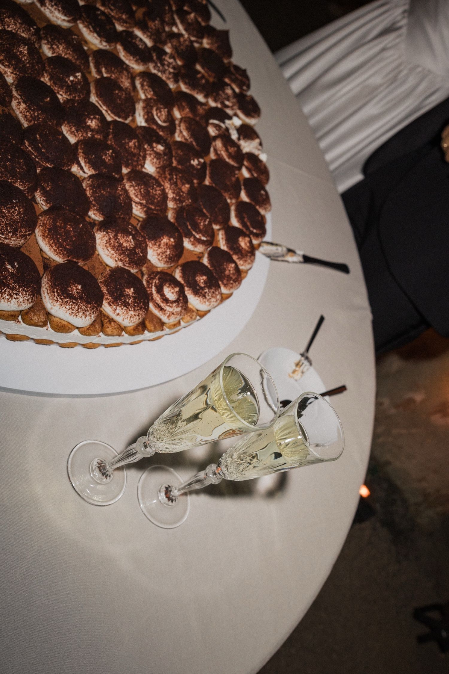 A sequence of images showing a dessert with chocolate tiramisu and a serving utensil on a white plate.