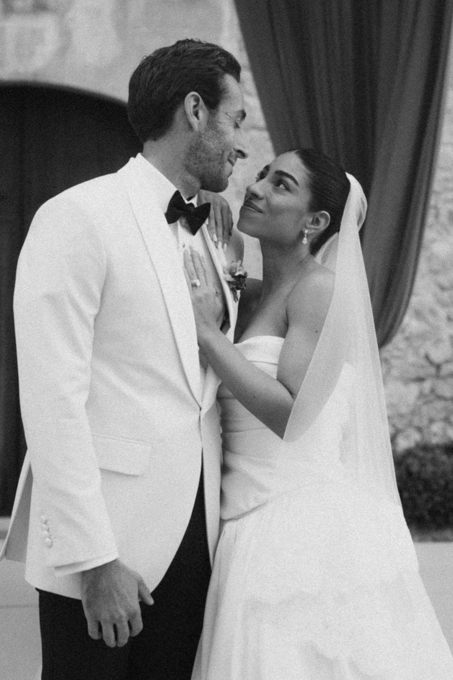 A romantic black and white wedding photo collage showing intimate moments between a bride and groom in formal attire.