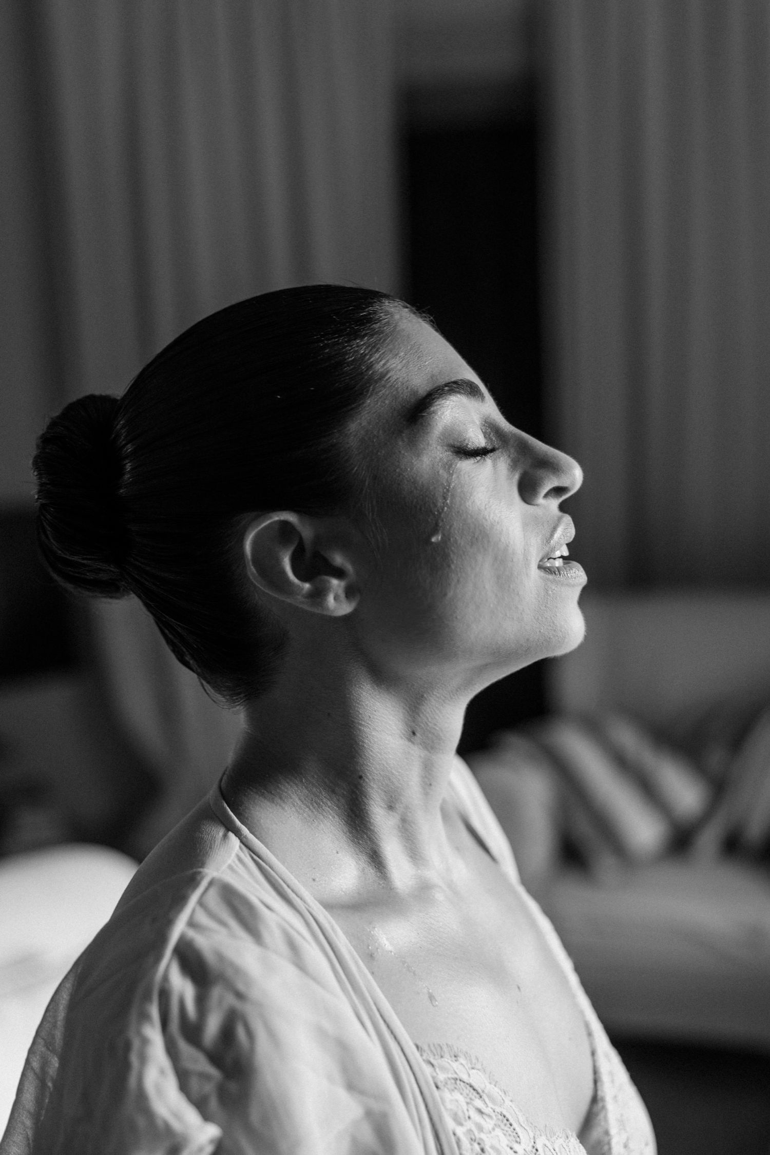 Black and white profile portraits showing a person with closed eyes in a sequence of emotional expressions.