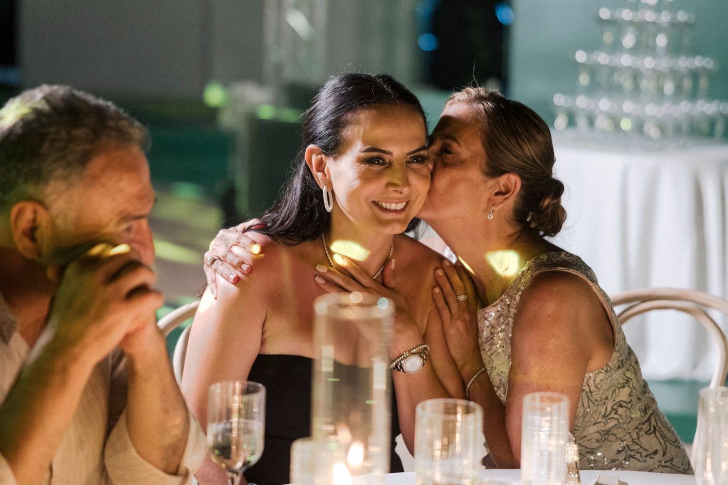 Newlyweds share intimate moments during their wedding reception celebration.