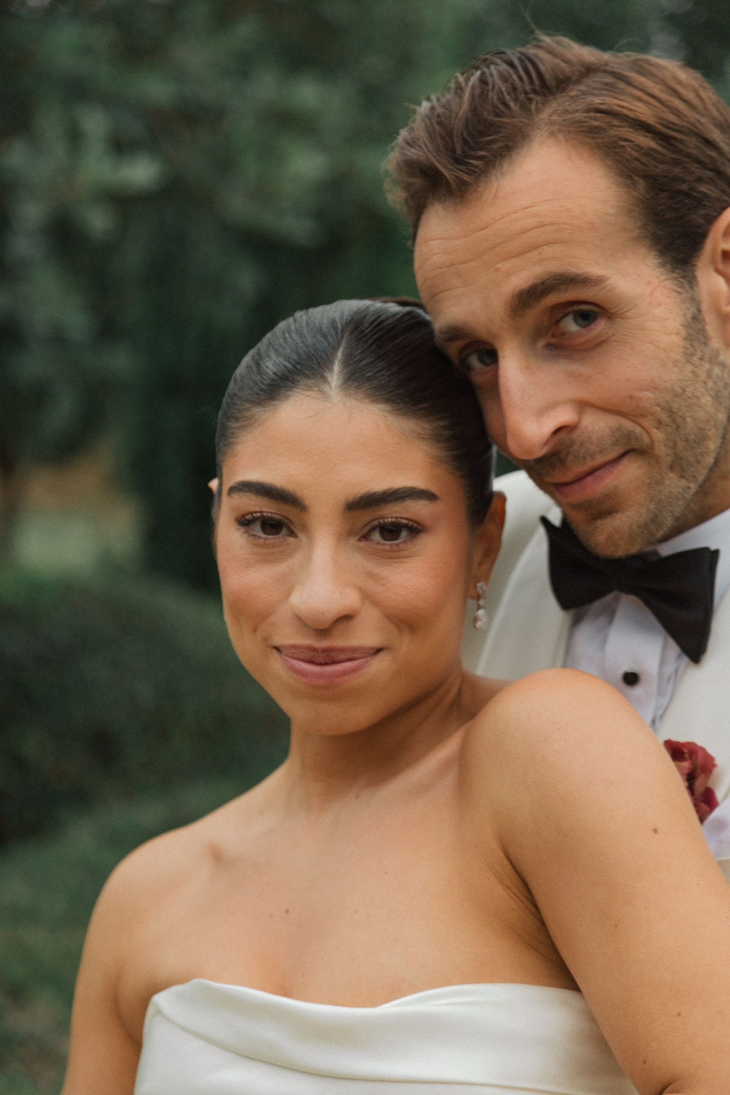 A romantic wedding couple shares intimate moments in a garden setting, with a series of candid close-up shots.