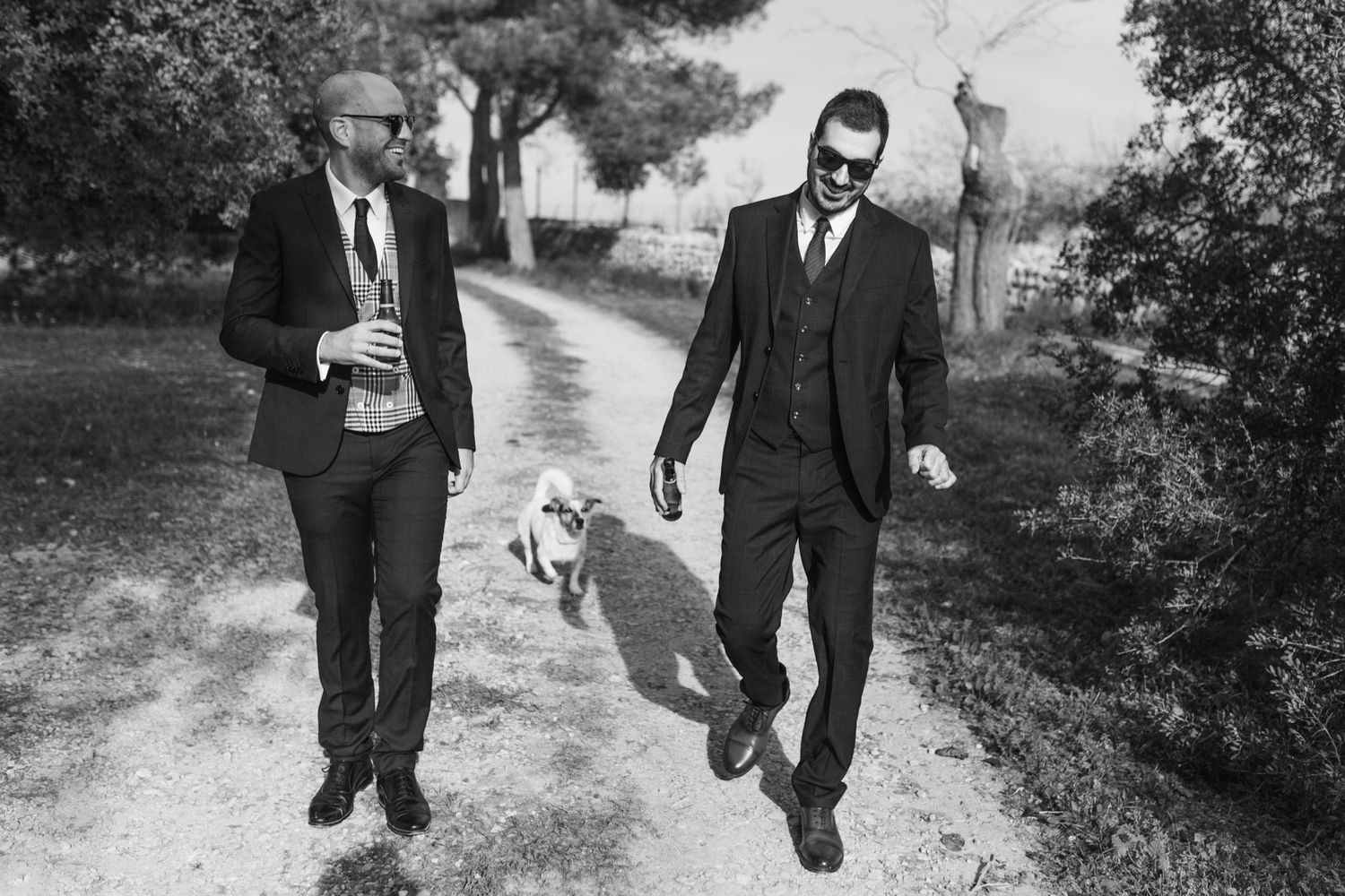 A series of vintage black and white photographs showing people walking along a rural path in formal attire.