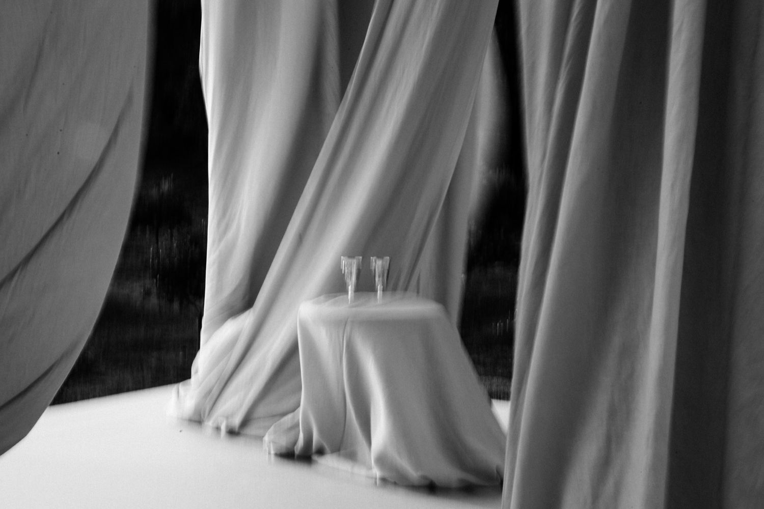 A row of elegant white wedding dresses hanging on display in a bridal boutique.