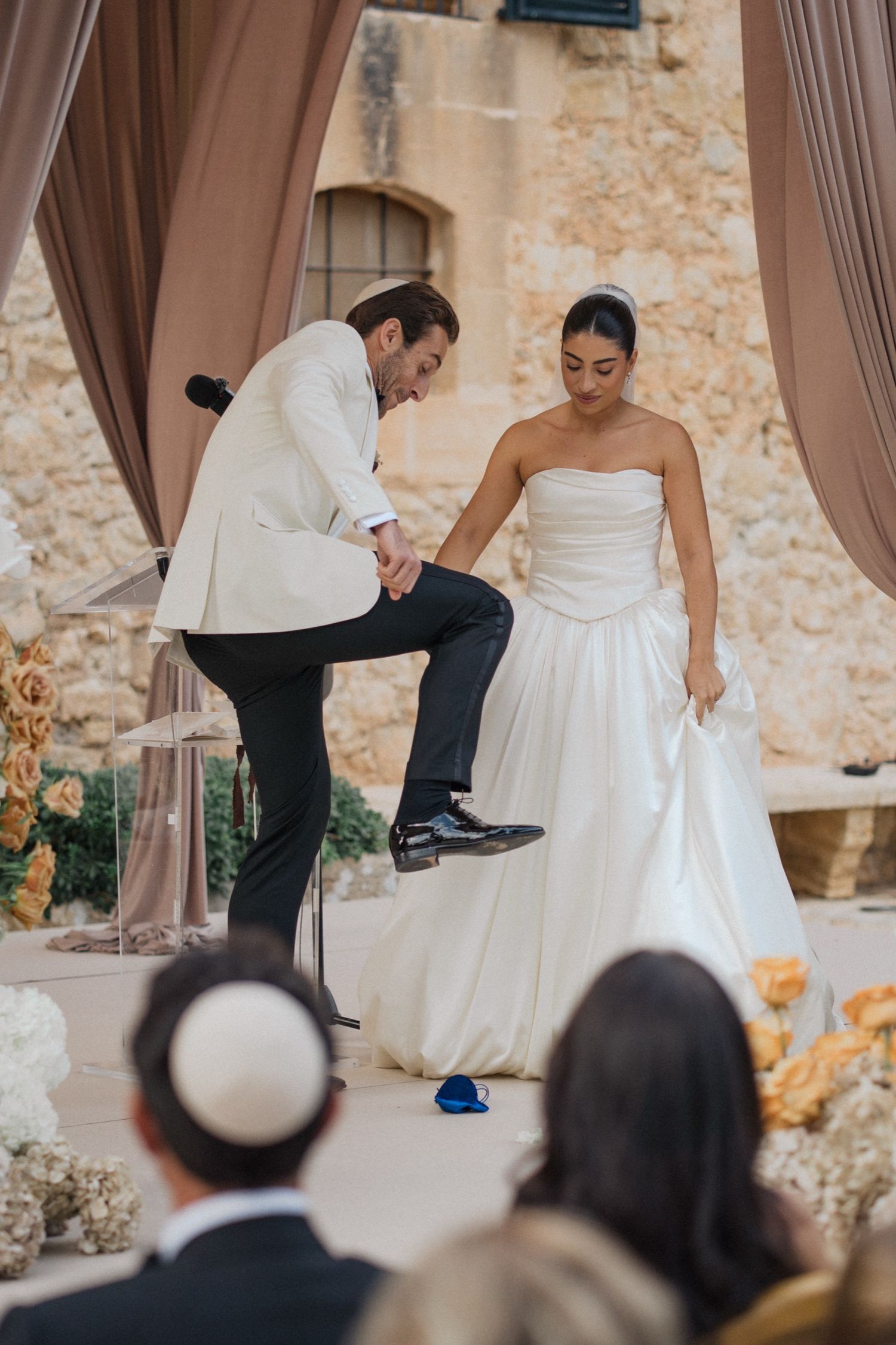 Wedding couple performs traditional Greek plate smashing dance ritual during their reception celebration.